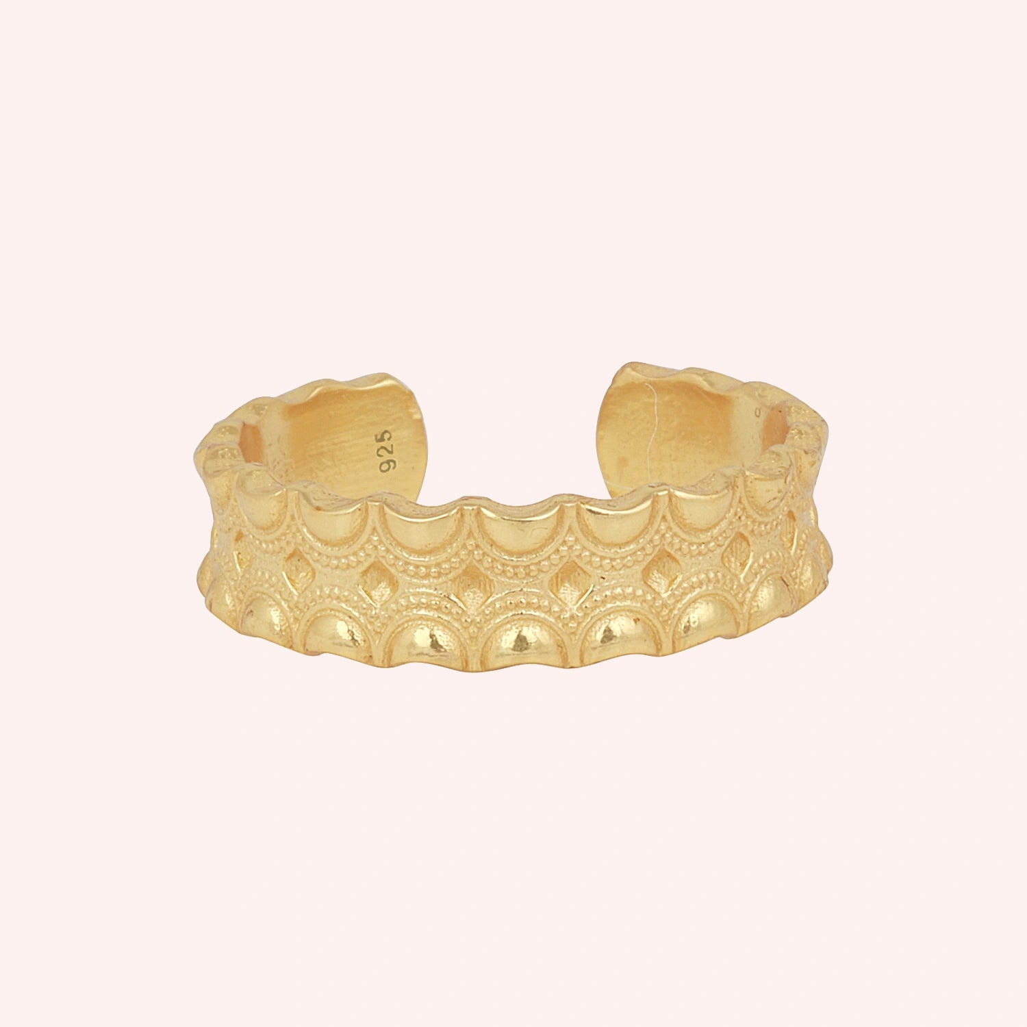Adjustable_ring_in_gold_plated_silver_with_handcrafted_deisgn_at_front_angle_on_solid_pink_background
