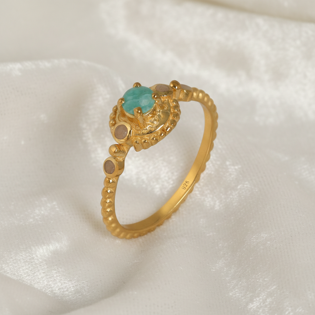 Amazonite-ring-with-round-amazonite-and-peach-moonstone-gold-plated-silver-angled-view-on-satin-background