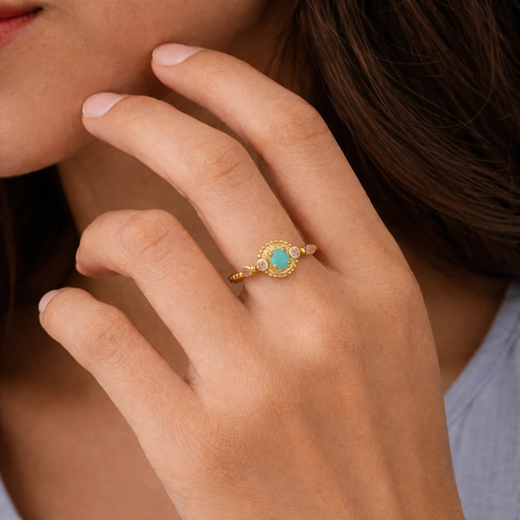 Amazonite-ring-with-round-amazonite-and-peach-moonstone-gold-plated-silver-angled-view-on-satin-background