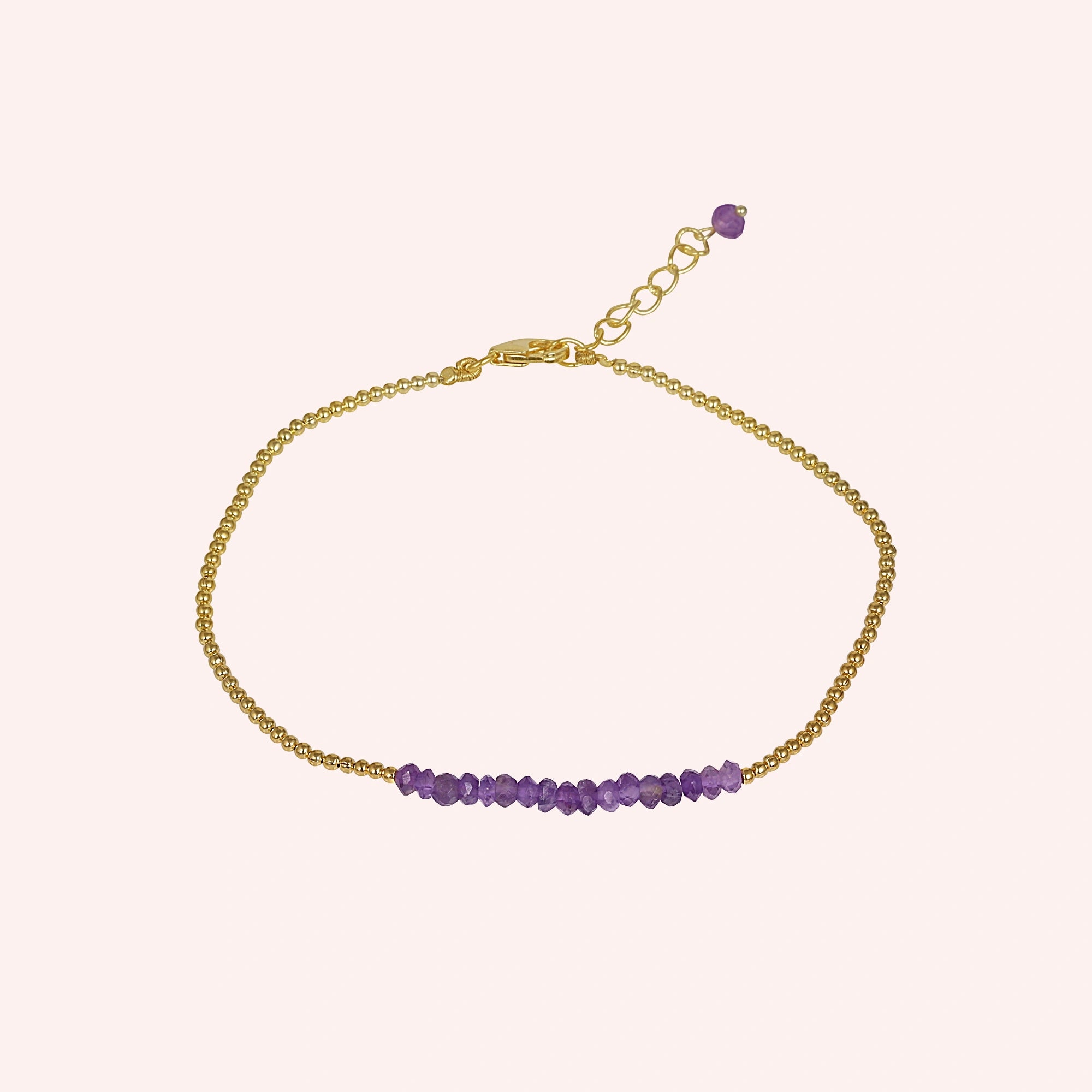 top_angle_amethyst_bracelet_with_amethyst_beads_bracelet_gold_plated_chain_centered_on_soft_pink_background