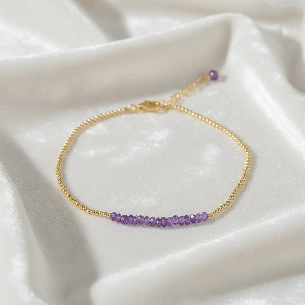 top_angle_amethyst_bracelet_gold_plated_with_amethyst_beads_bracelet_on_soft_silk_background_delicate_chain