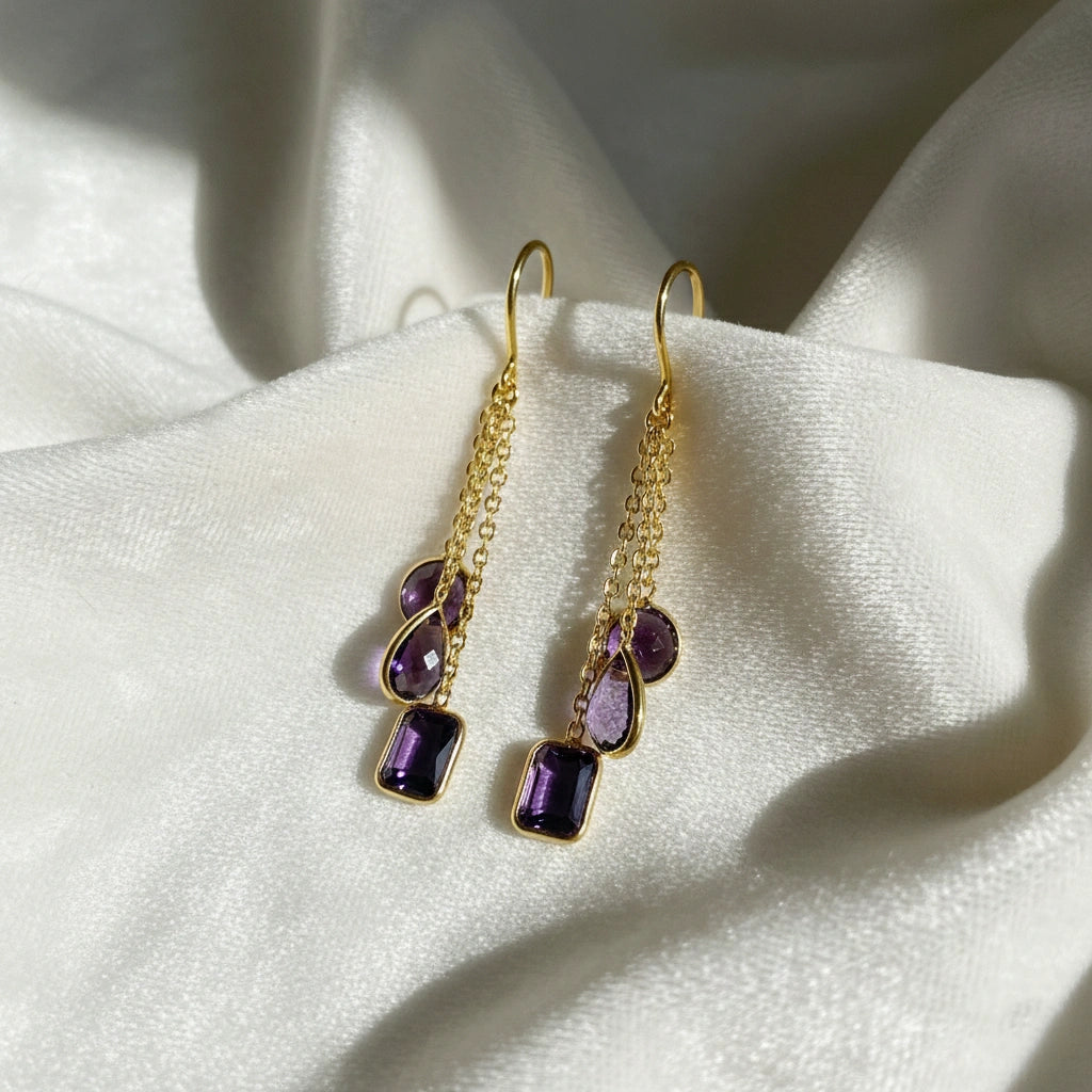 boho_earrings_top_angle_gold_plated_chain_drop_amethyst_earrings_with_purple_gemstones_on_white_silk_background_soft_shine