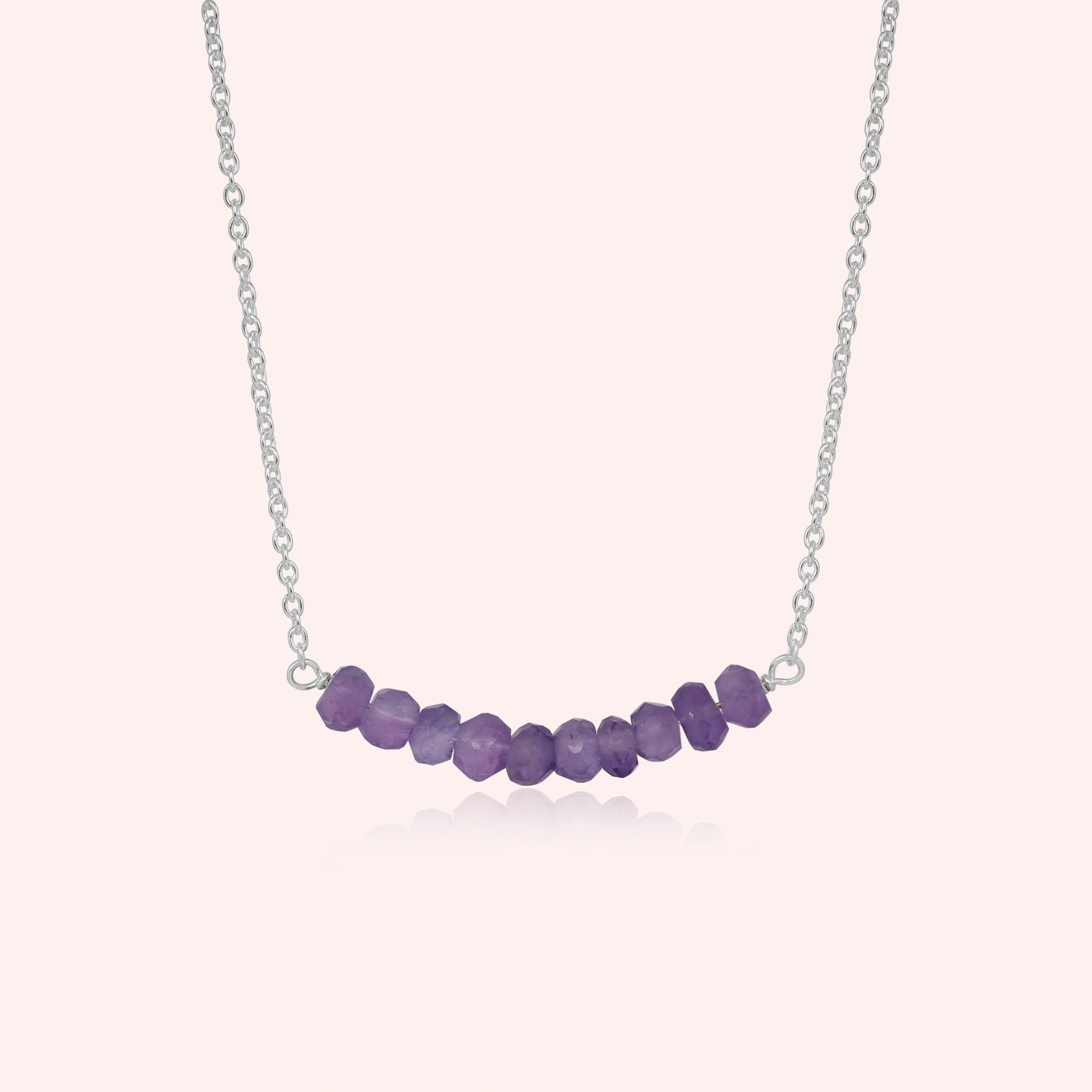 Front_view_amethyst_necklace_with_purple_stone_beads_on_silver_chain_beaded_necklace_on_soft_pink_background