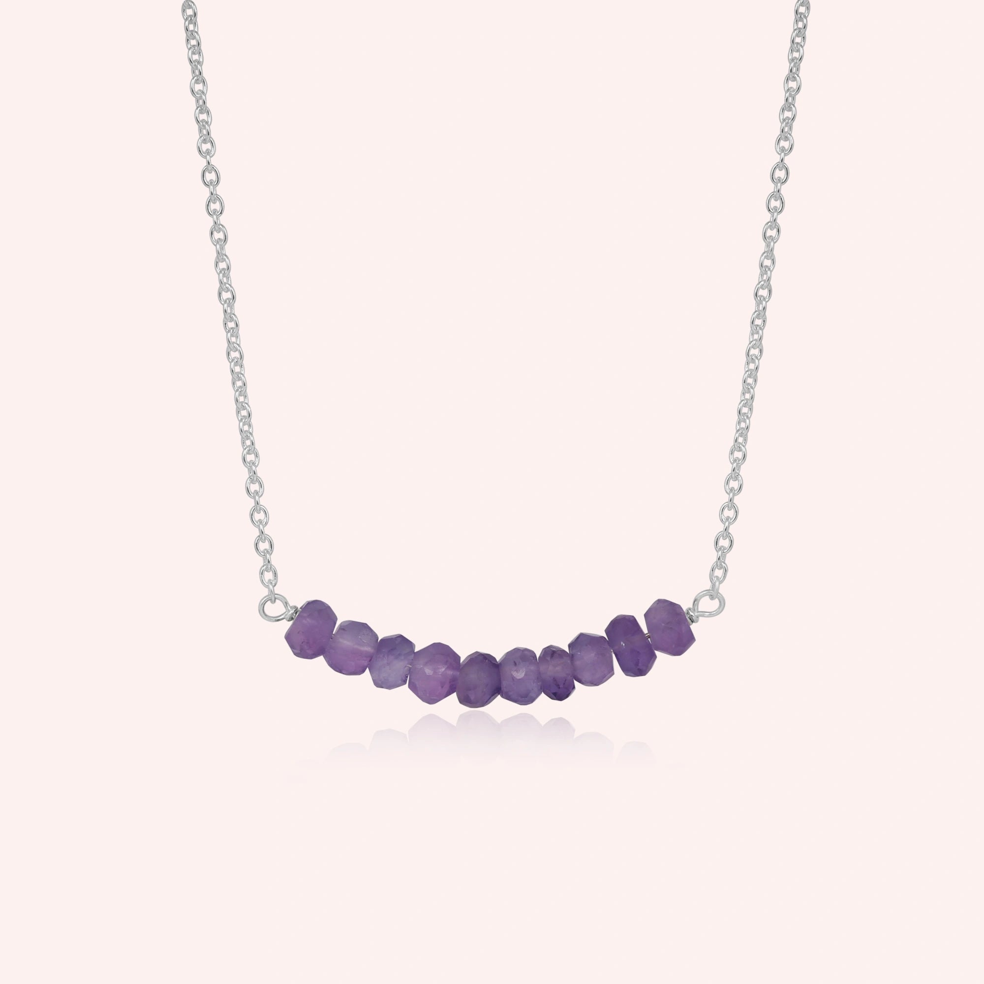Front_view_amethyst_necklace_with_purple_stone_beads_on_silver_chain_beaded_necklace_on_soft_pink_background