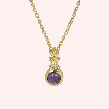 Amethyst_necklace_in_gold_plated_silver_with_amethyst_and_crystal_stones_at_front_angle_view_on_solid_pink_background
