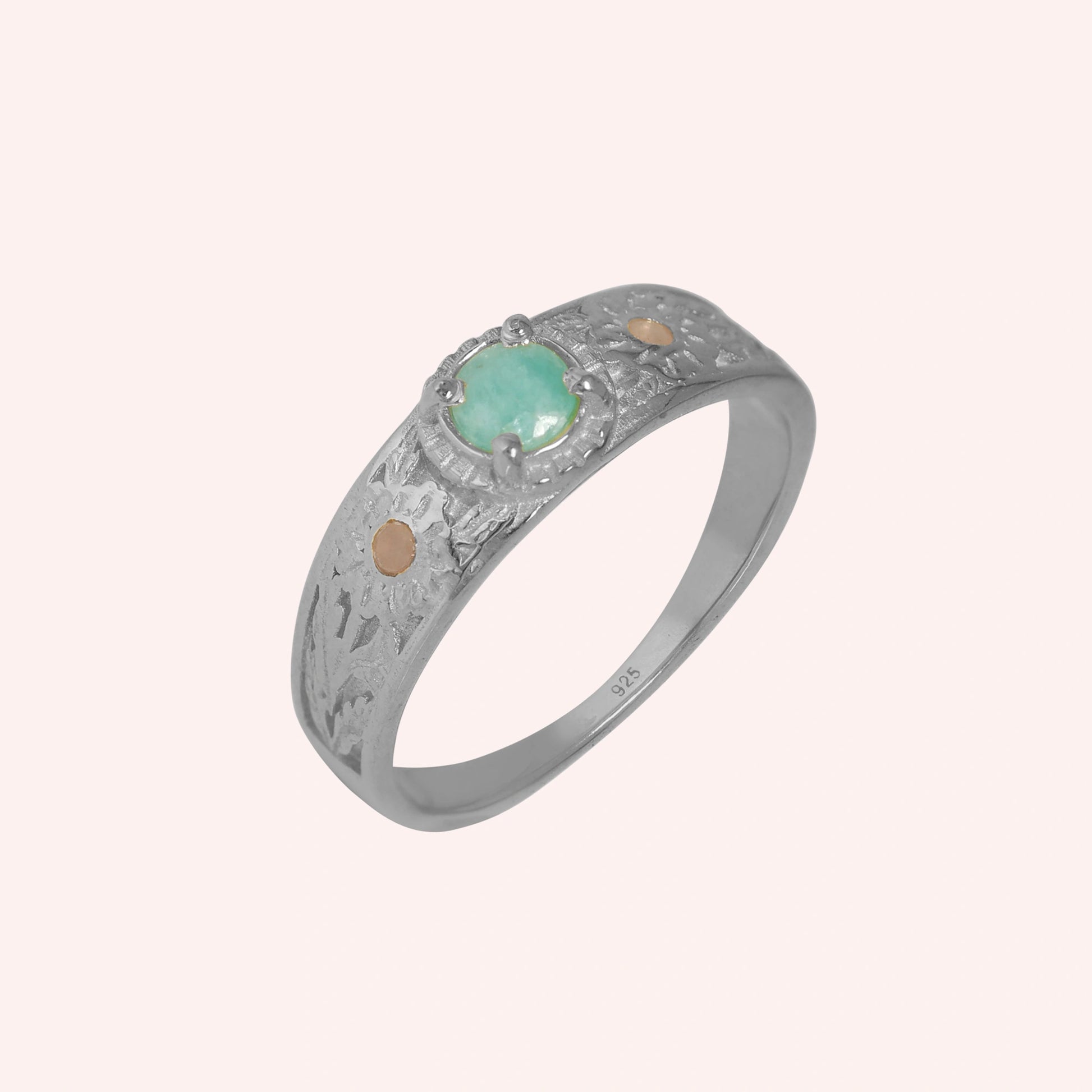 Art-deco-ring-in-sterling-silver-with-blue-center-stone-and-textured-band-side-angled-view-on-solid-pink-background