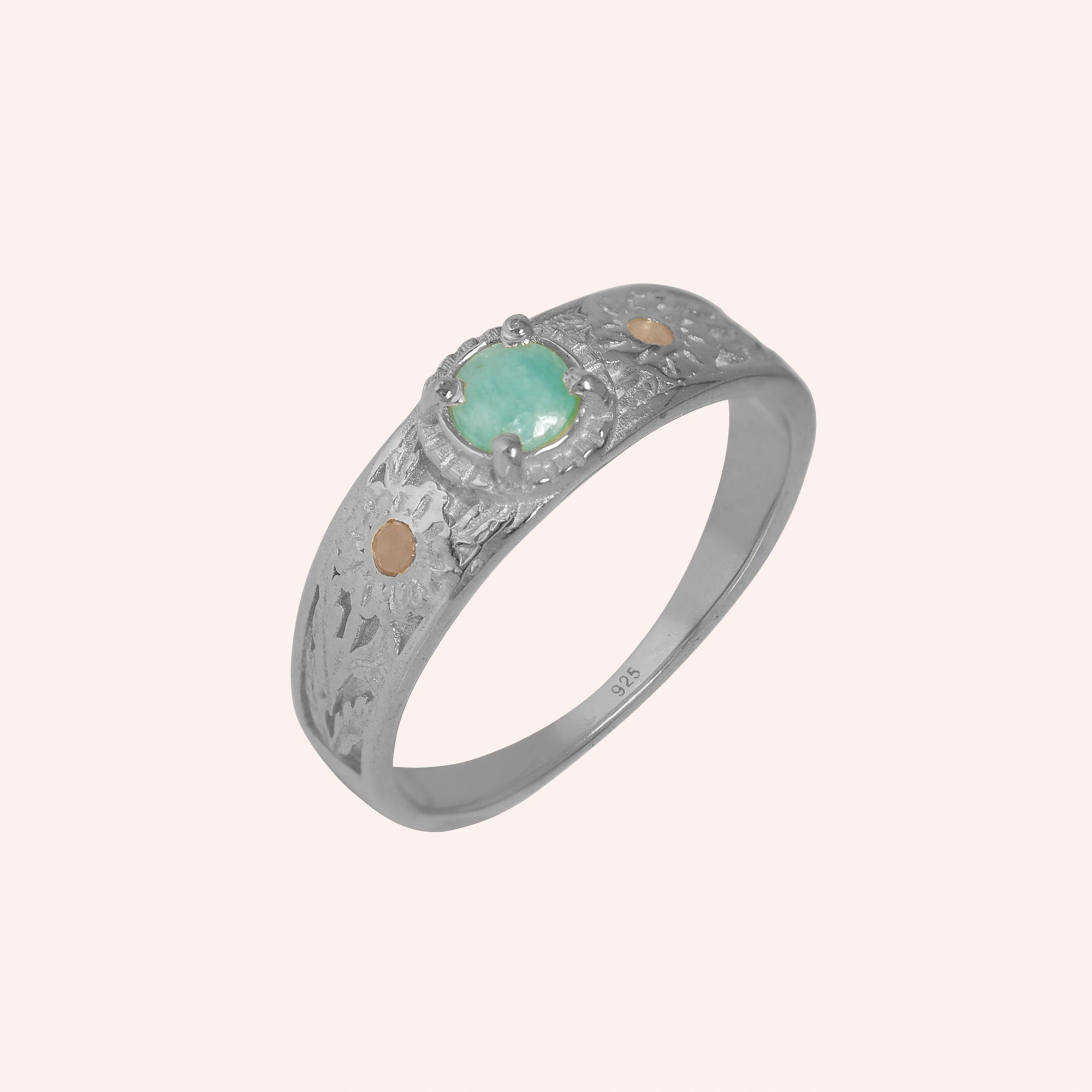 Art-deco-ring-in-sterling-silver-with-blue-center-stone-and-textured-band-side-angled-view-on-solid-pink-background