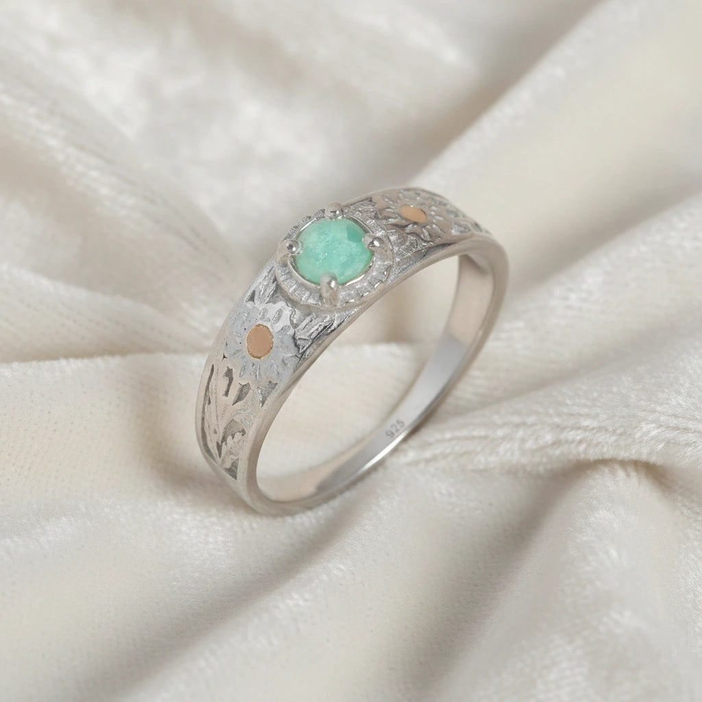 Art-deco-ring-in-sterling-silver-with-blue-center-stone-and-textured-band-side-angled-view-on-soft-white-fabric-background