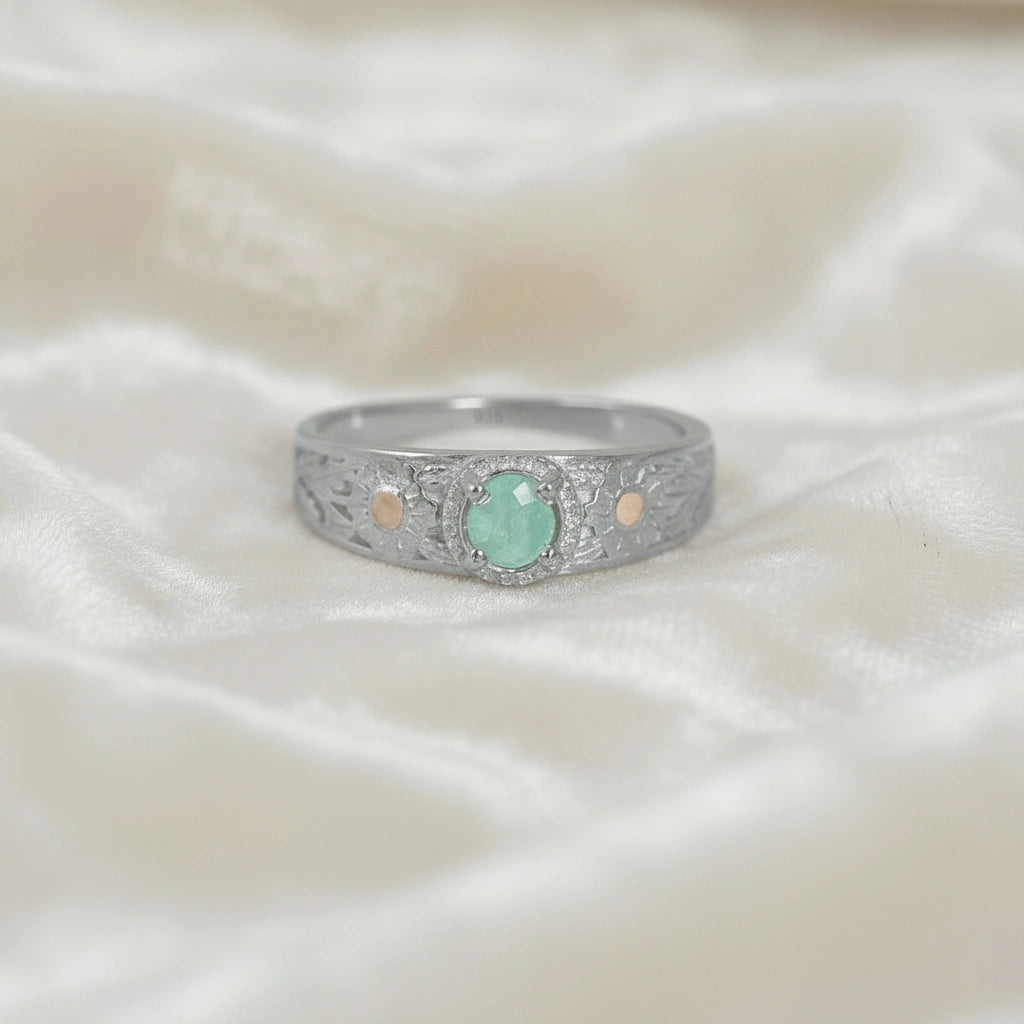 Art-deco-ring-in-sterling-silver-with-blue-center-stone-and-textured-band-front-angle-view-on-soft-white-fabric-background