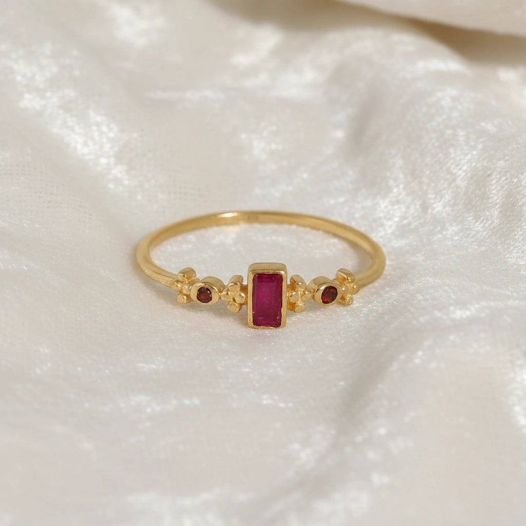 Baguette-ring-with-ruby-and-garnet-gemstones-gold-plated-silver-front-view-on-white-satin-background