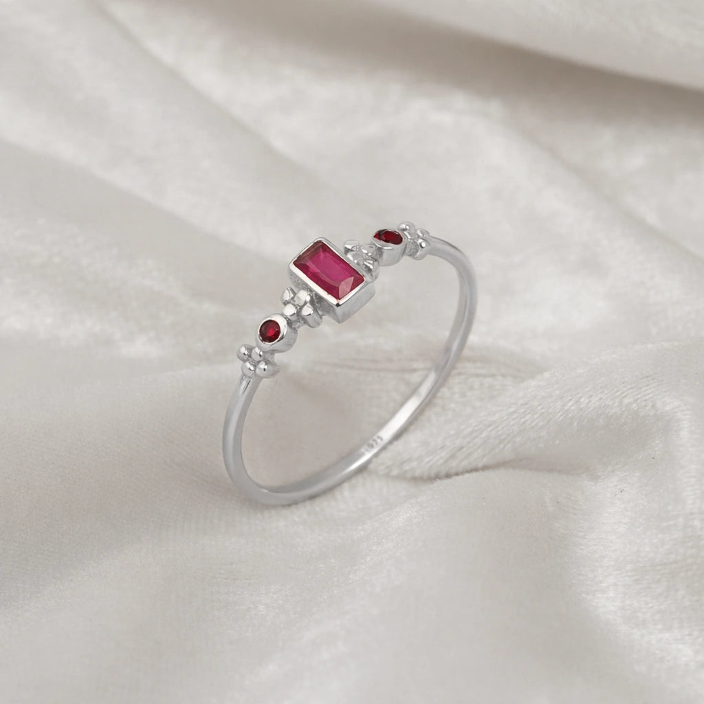 Baguette-ring-with-ruby-and-garnet-gemstones-sterling-silver-front-view-on-white-satin-background