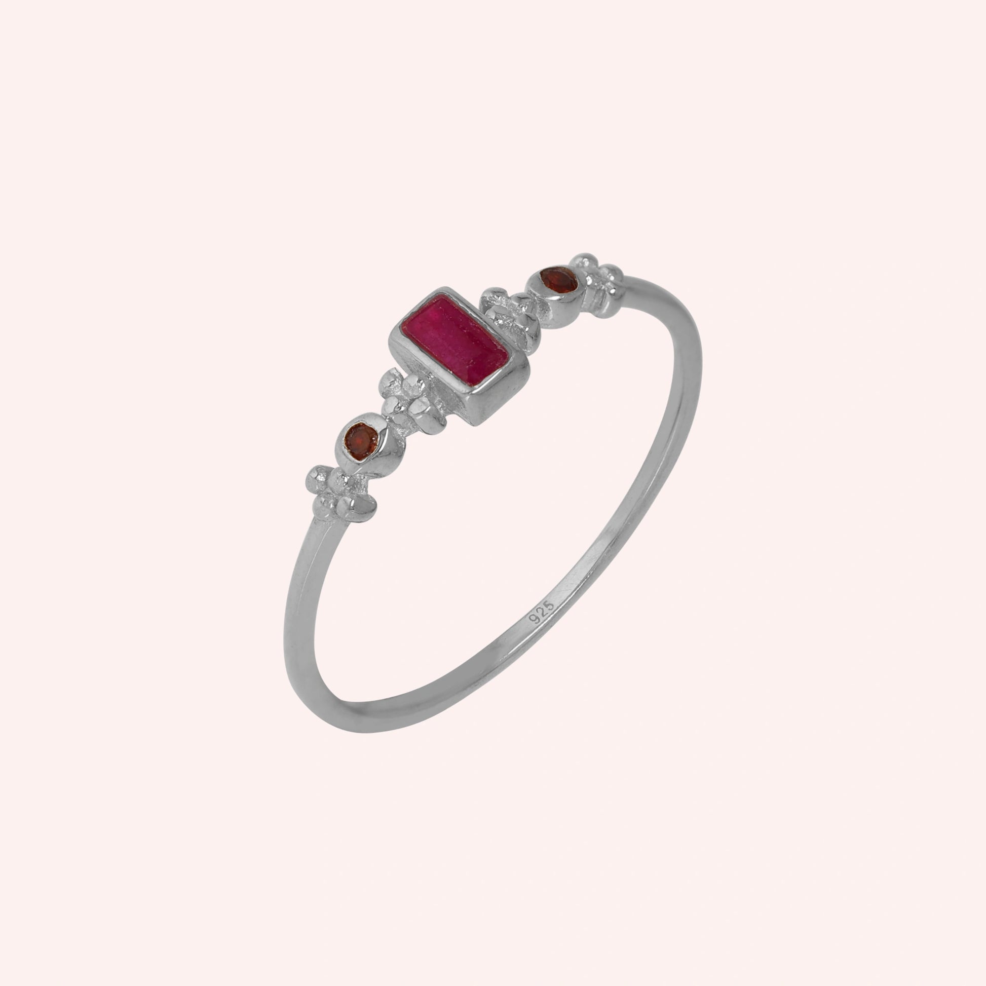 Baguette-ring-with-ruby-and-garnet-gemstones-sterling-silver-front-view-on-soft-pink-background