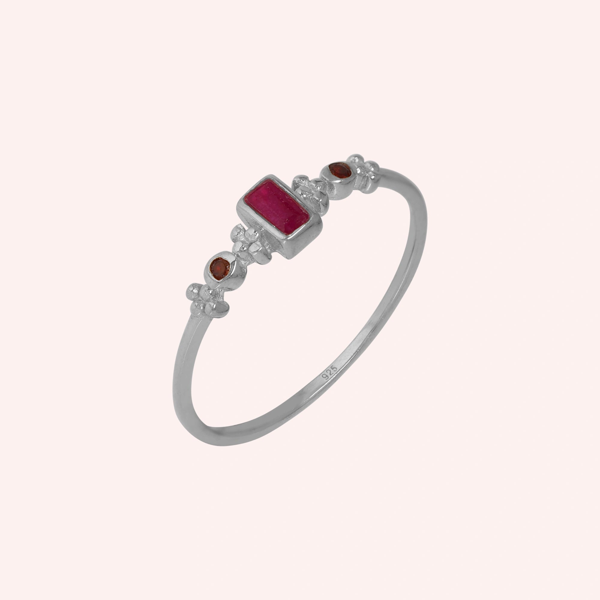 Baguette-ring-with-ruby-and-garnet-gemstones-sterling-silver-front-view-on-soft-pink-background