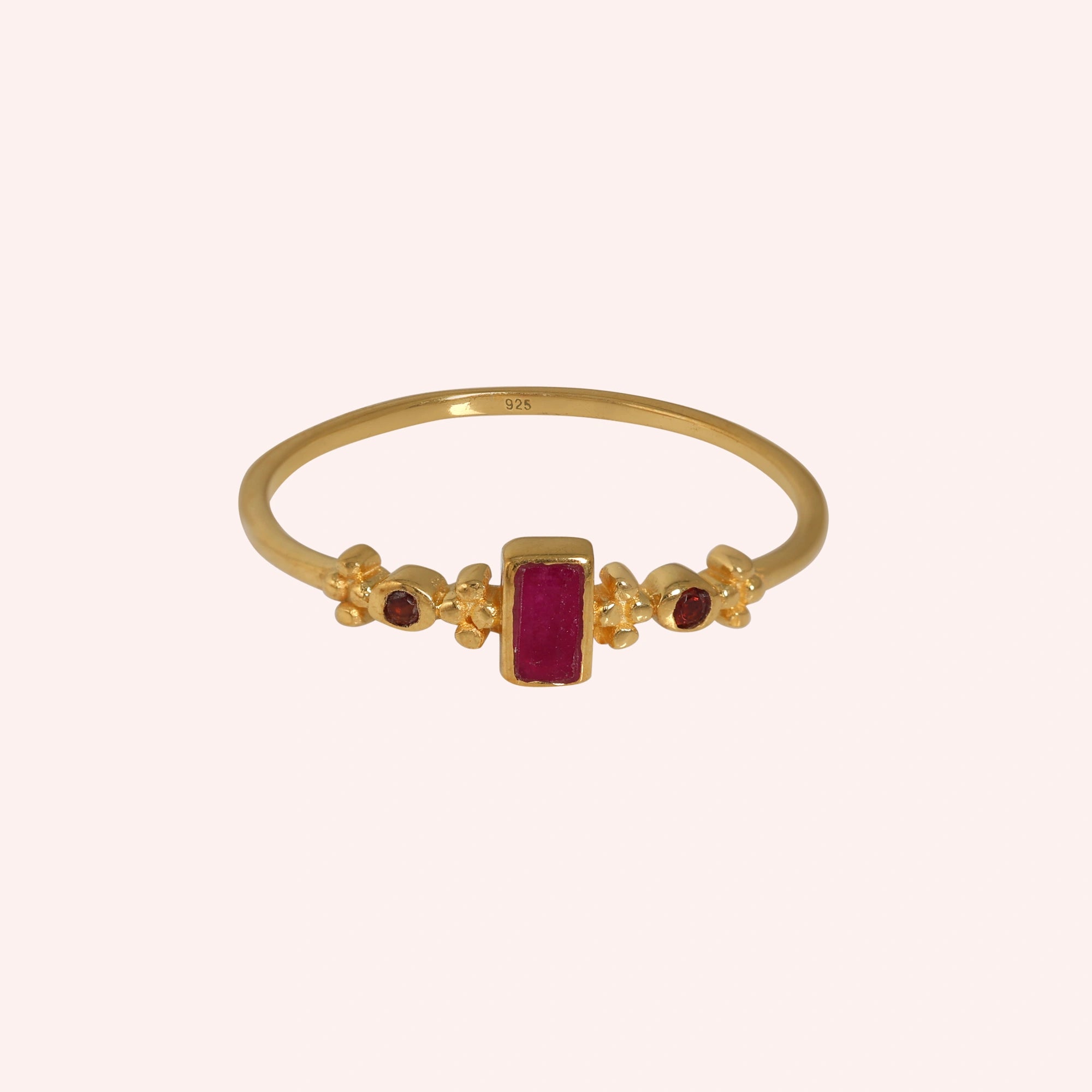 Baguette-ring-with-ruby-and-garnet-gemstones-gold-plated-silver-front-view-on-soft-pink-background