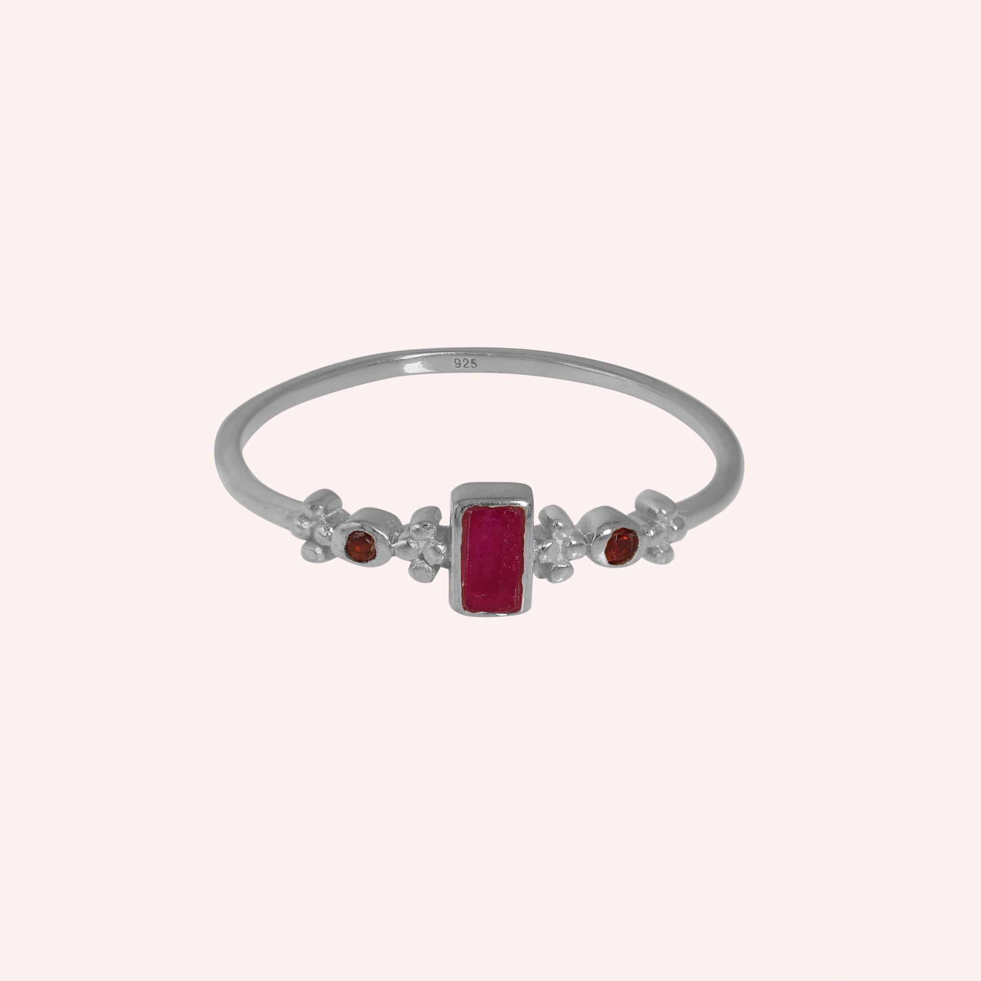 Baguette-ring-with-ruby-and-garnet-gemstones-sterling-silver-front-view-on-soft-pink-background