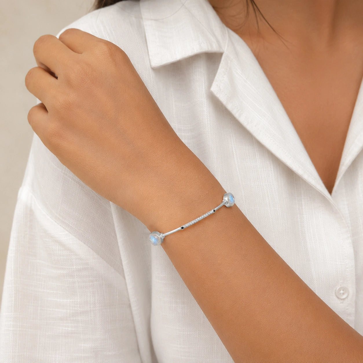 Bangle_bracelet_in_sterling_silver_with_oval_moonstones_and_black_onyx_stones_worn_by_a_model