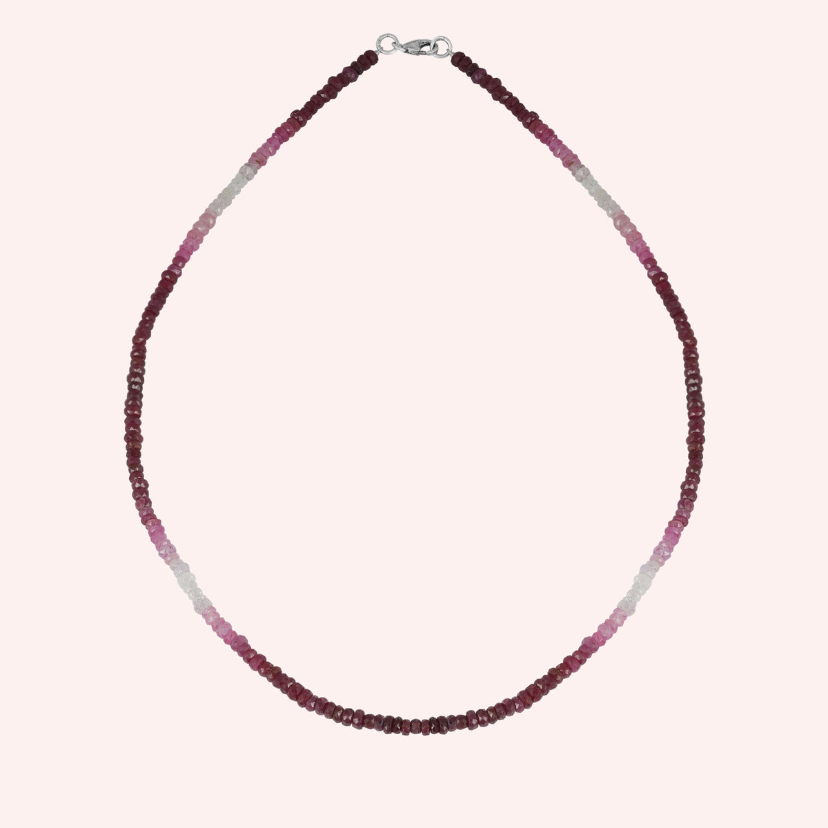 Beaded_necklace_in_ombre_effect_with_ruby_stones_in_gradient_design_in_front_angle_on_solid_pink_background