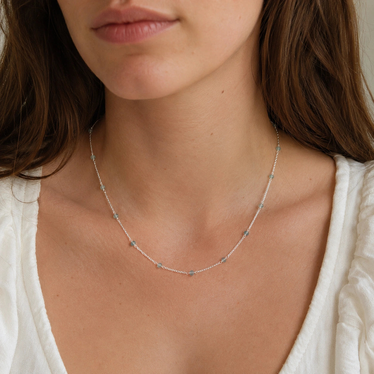 Beads_necklace_in_sterling_silver_with_aquamarine_stones_worn_by_a_model