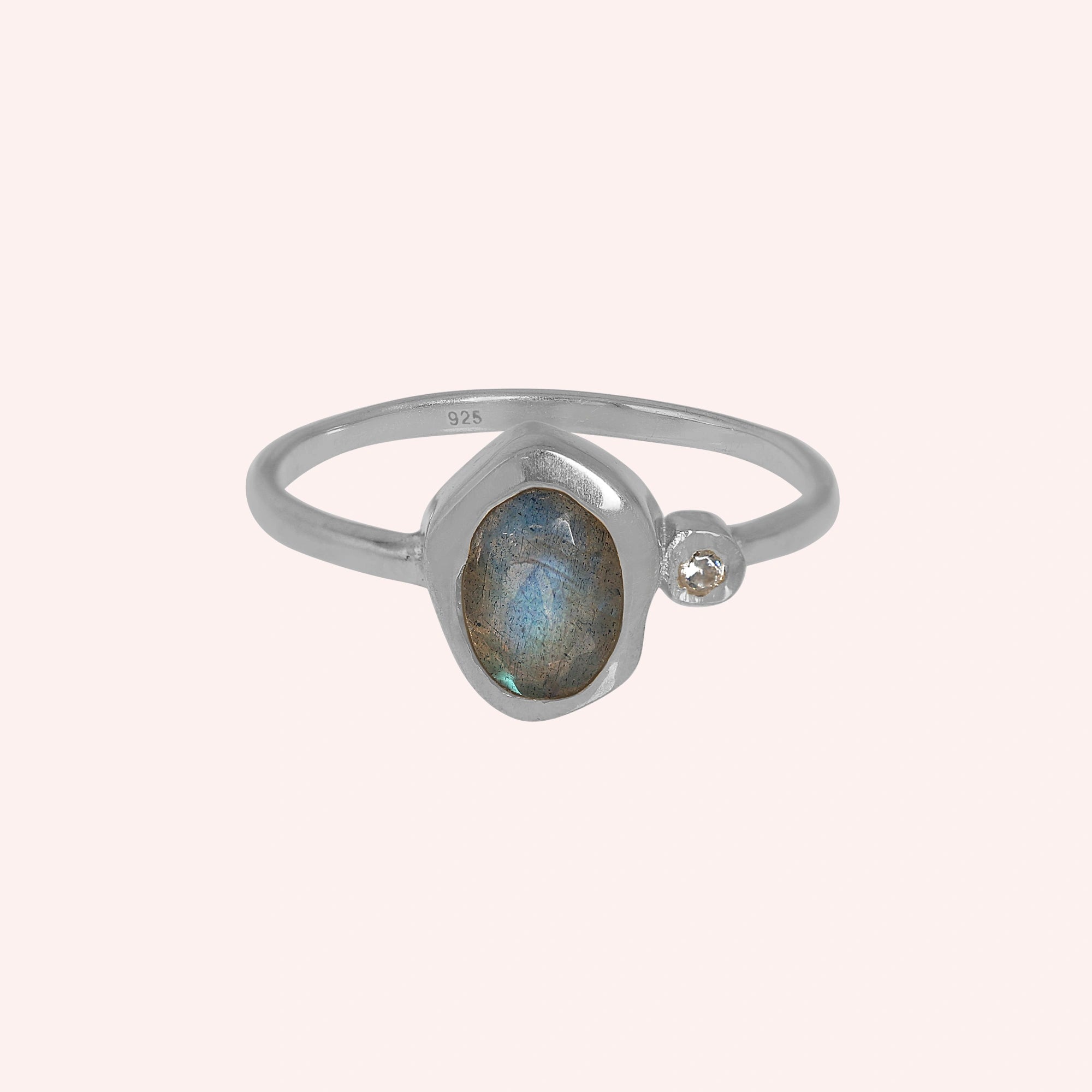 Bezel-set-ring-with-labradorite-and-white-topaz-stones-sterling-silver-front-view-on-soft-pink-background