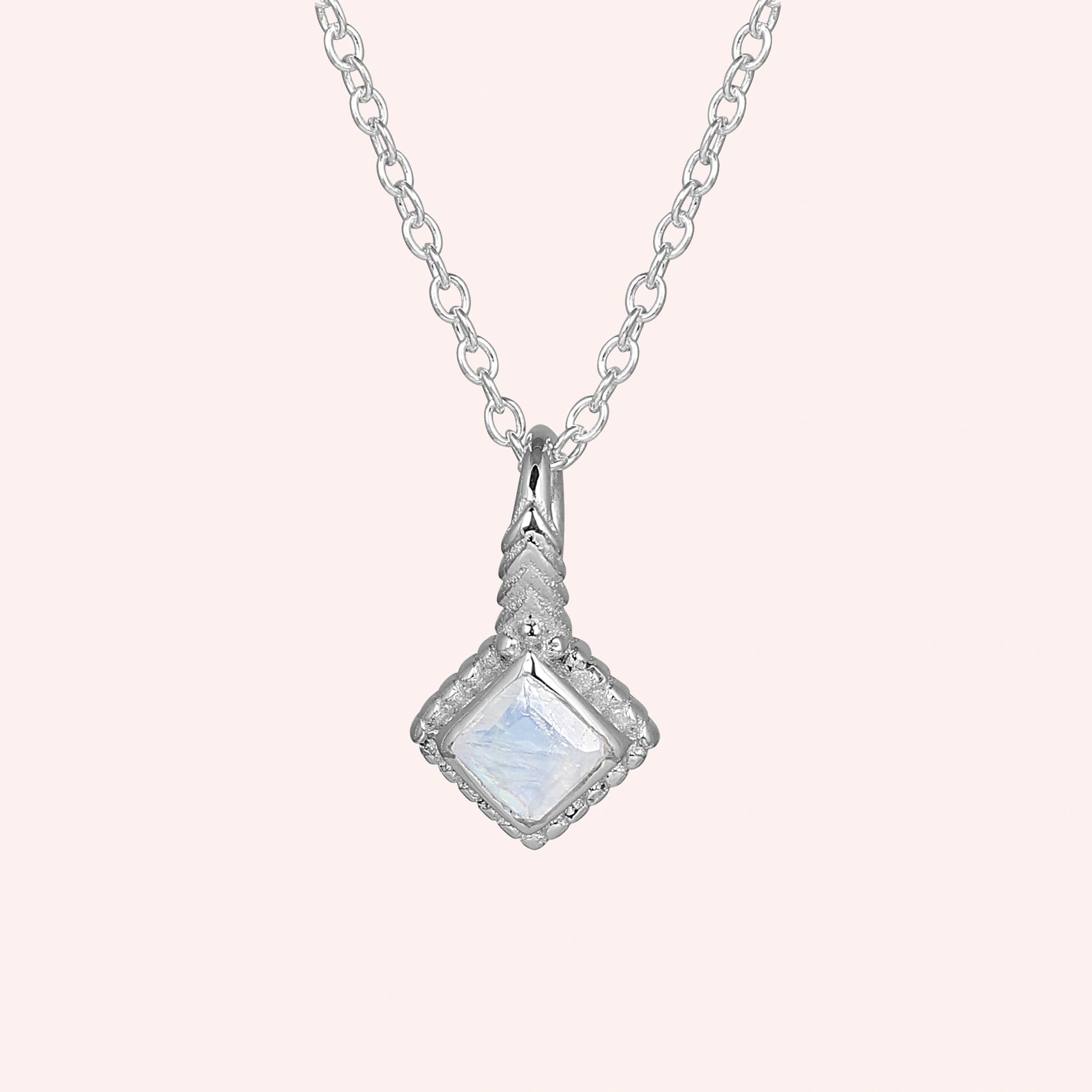 Birthstone_necklace_in_sterling_silver_with_square_cut_moonstone_pendant_in_front_angle_view_on_solid_pink_background