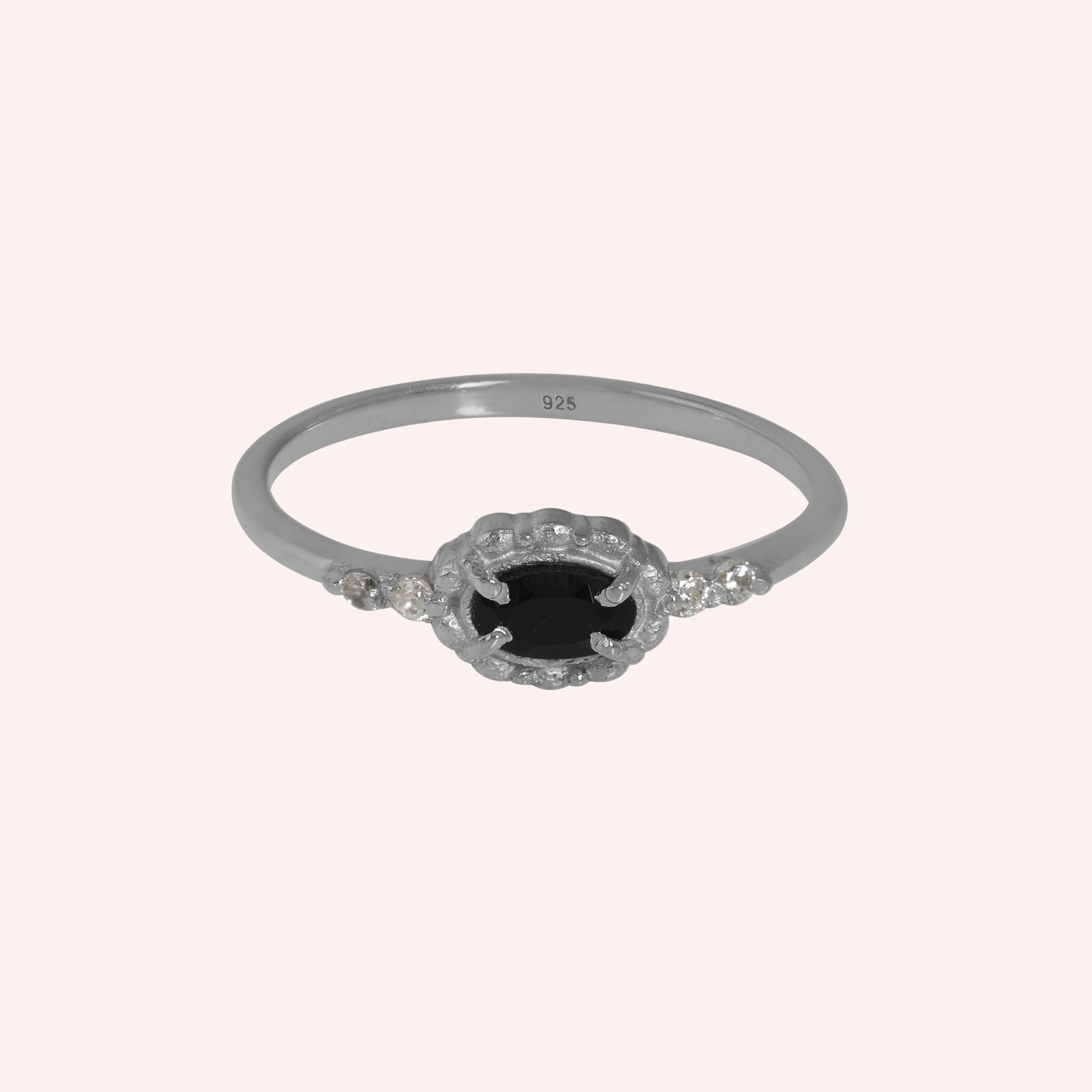 Black-onyx-ring-with-white-topaz-stones-sterling-silver-front-view-on-soft-pink-background
