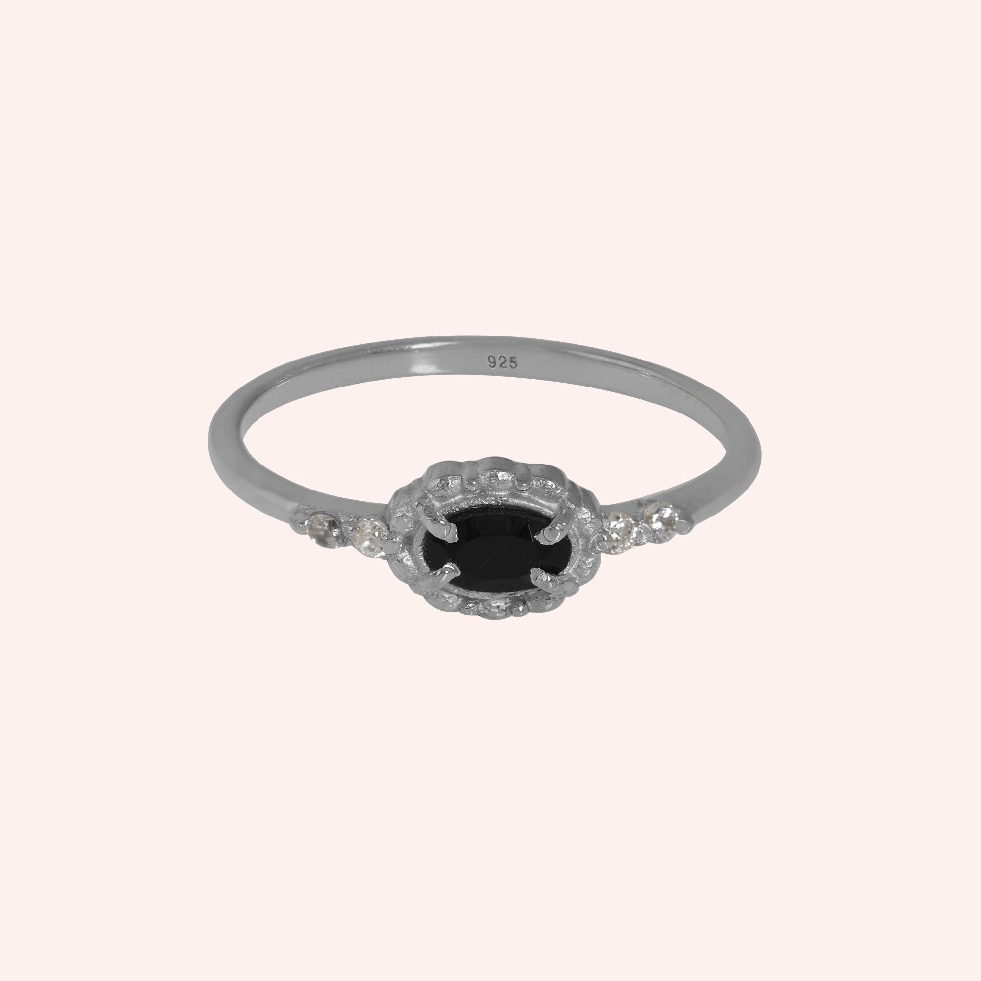 Black-onyx-ring-with-white-topaz-stones-sterling-silver-front-view-on-soft-pink-background