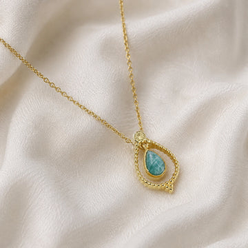 Blue_stone_necklace_in_gold_plated_silver_at_slightly_angled_featuring_amazonite_stone_on_soft_fabric_background