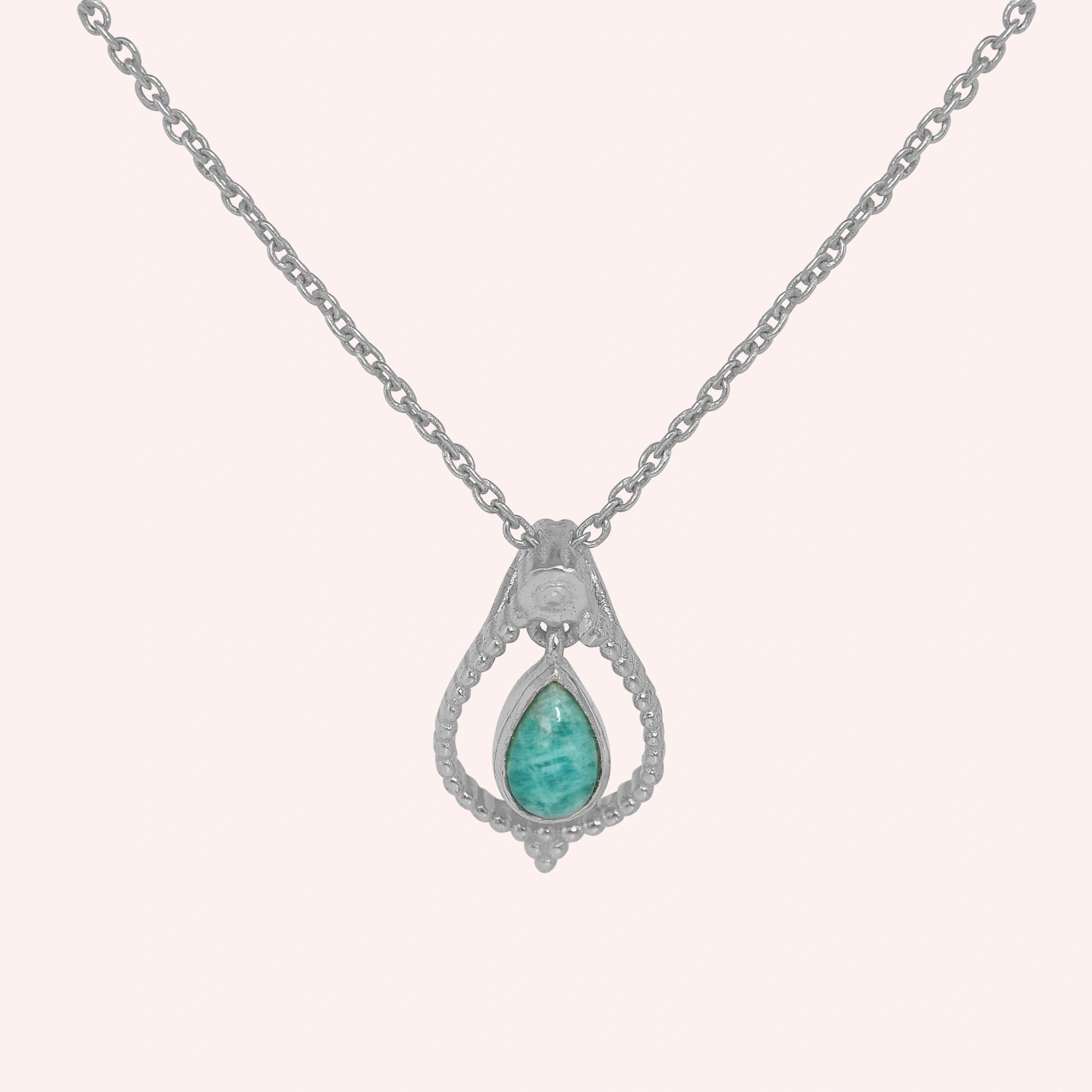 Blue_stone_necklace_in_sterling_silver_at_front_angled_featuring_amazonite_stone_on_solid_pink_background