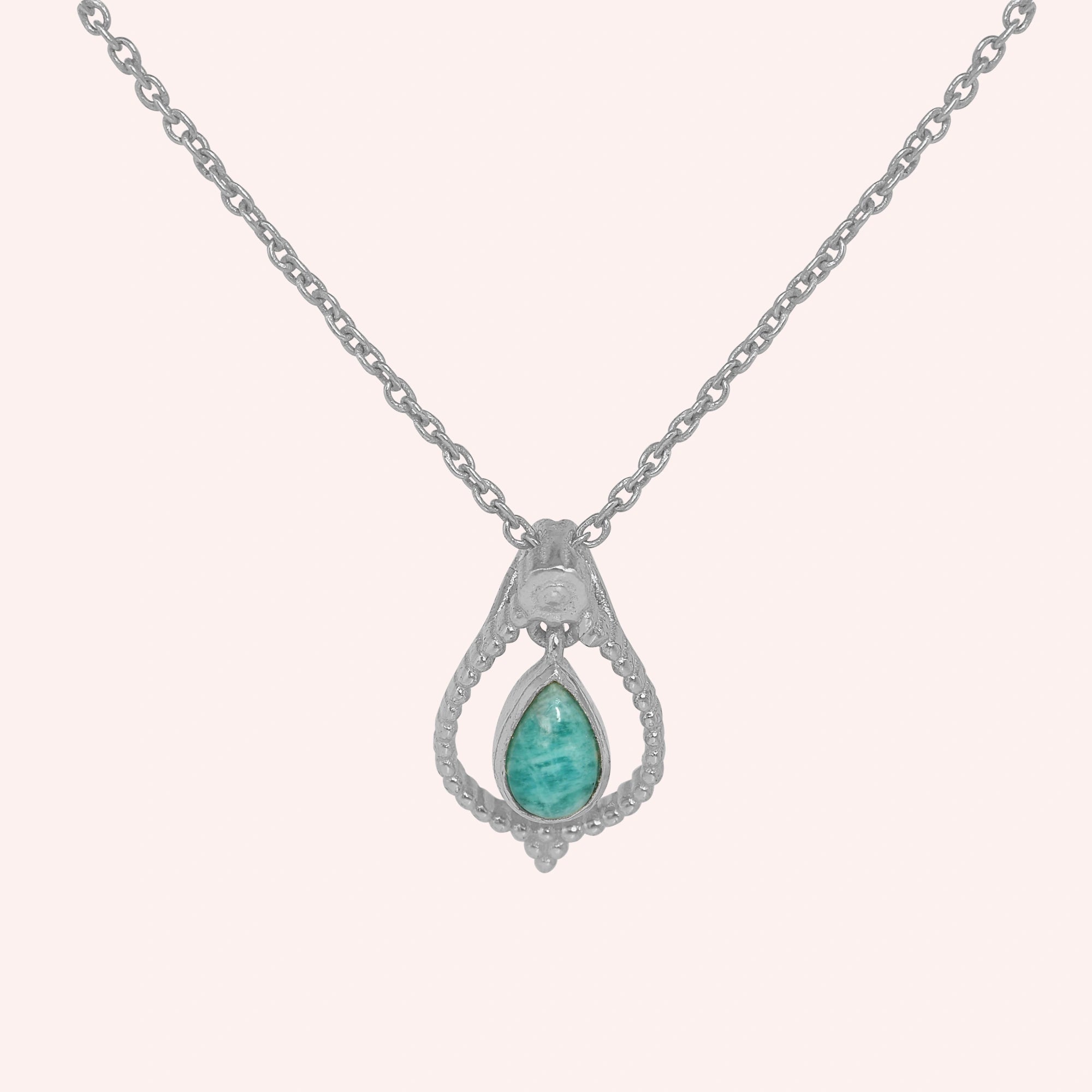 Blue_stone_necklace_in_sterling_silver_at_front_angled_featuring_amazonite_stone_on_solid_pink_background
