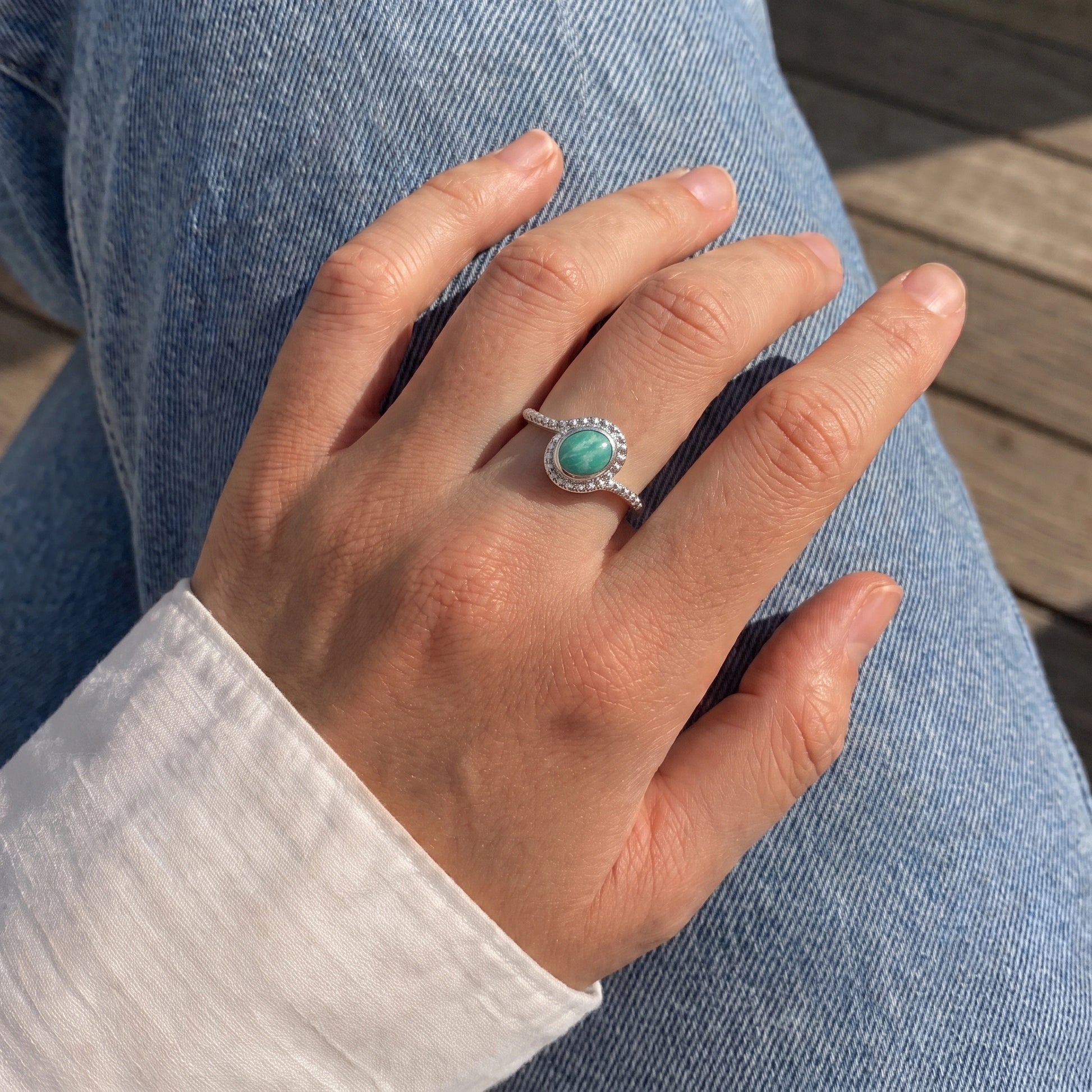 Blue_stone_ring_in_sterling_silver_with_an_oval_amazonite_stone_worn_by_a_model