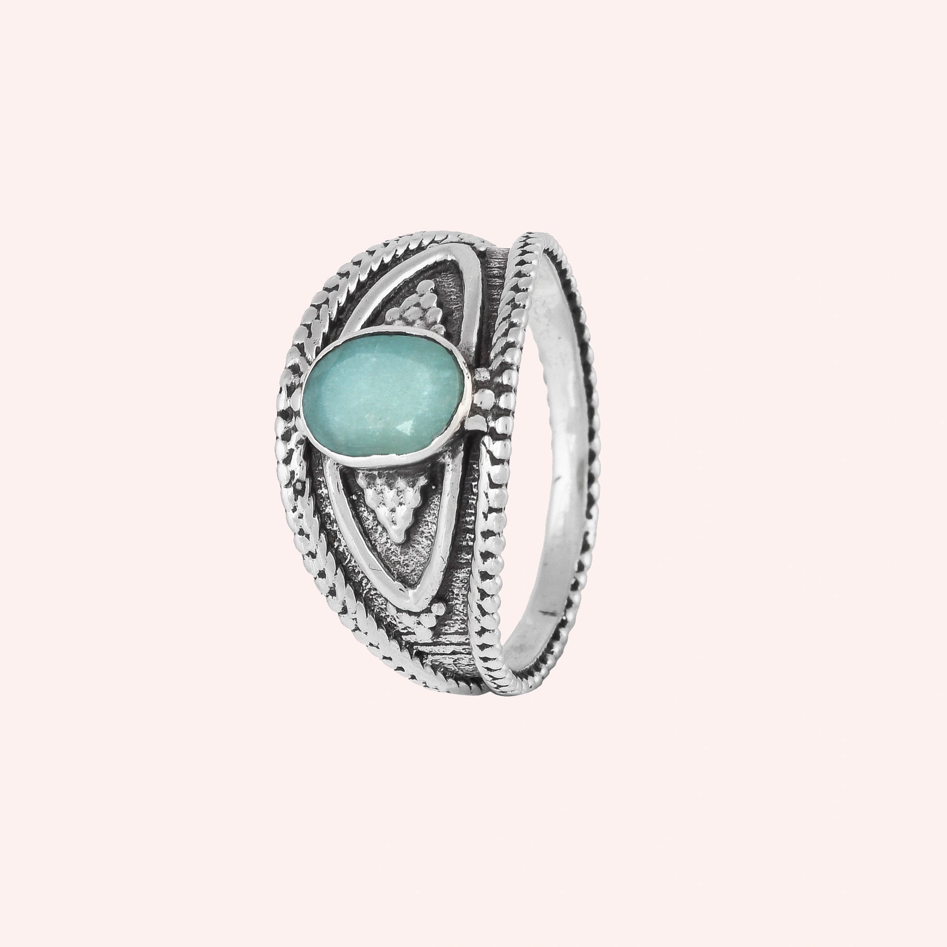 Boho_ring_with_amazonite_stone_sterling_silver_with_filigree_texture_in_slightly_angled_on_solid_pink_background