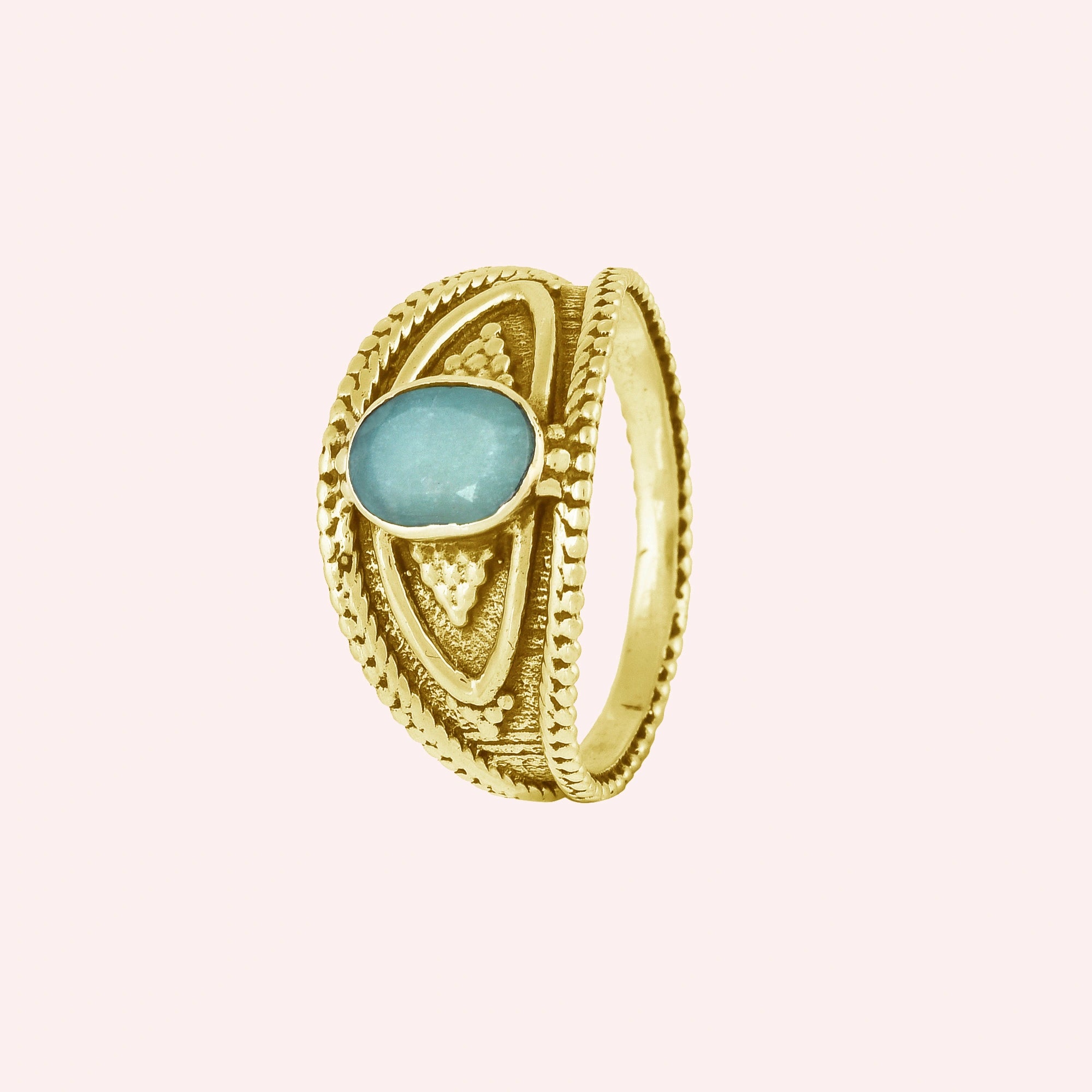 Boho_ring_with_amazonite_stone_gold_plated_silver_with_filigree_texture_in_slightly_angled_on_solid_pink_background