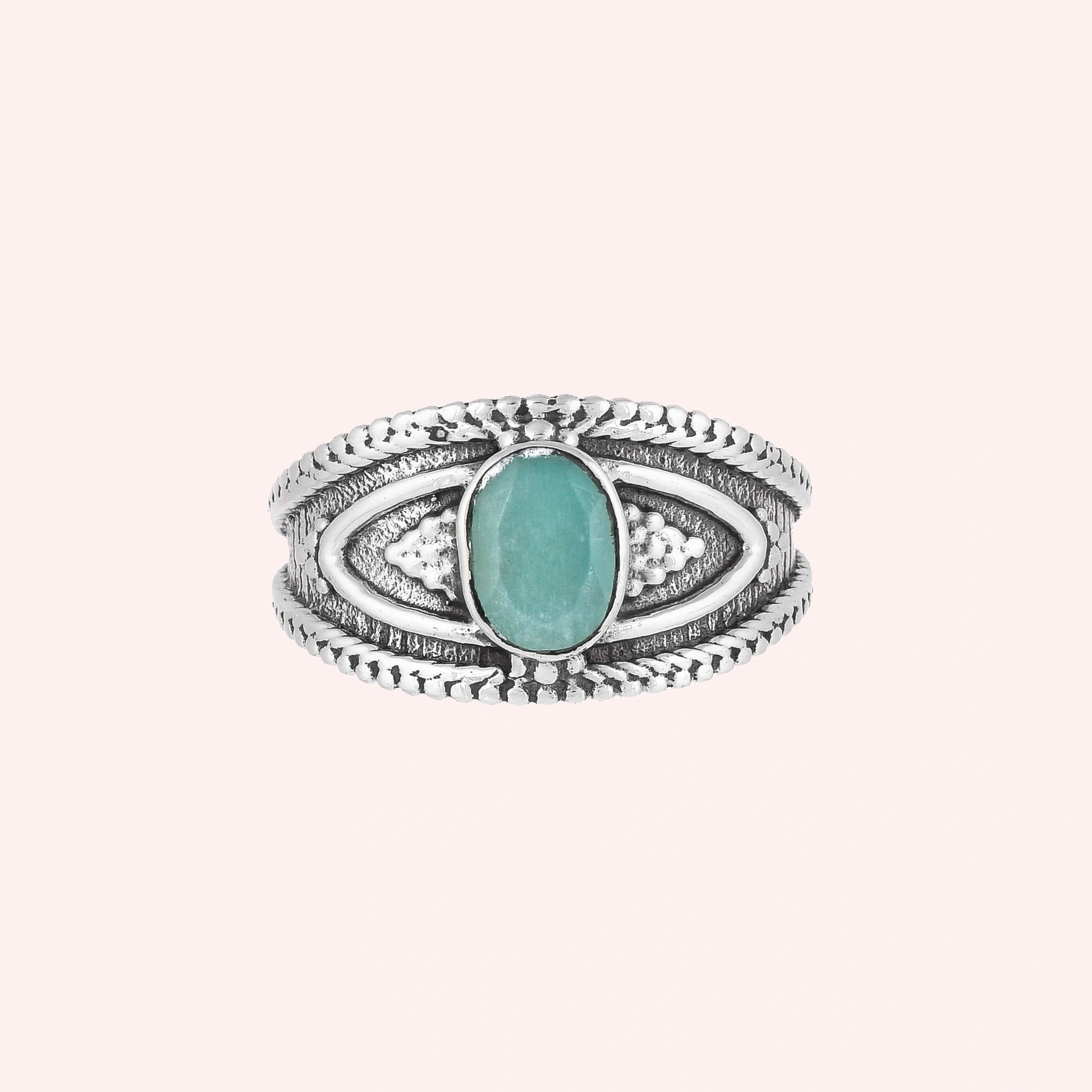 Boho_ring_with_amazonite_stone_sterling_silver_with_filigree_texture_in_front_angle_view_on_solid_pink_background