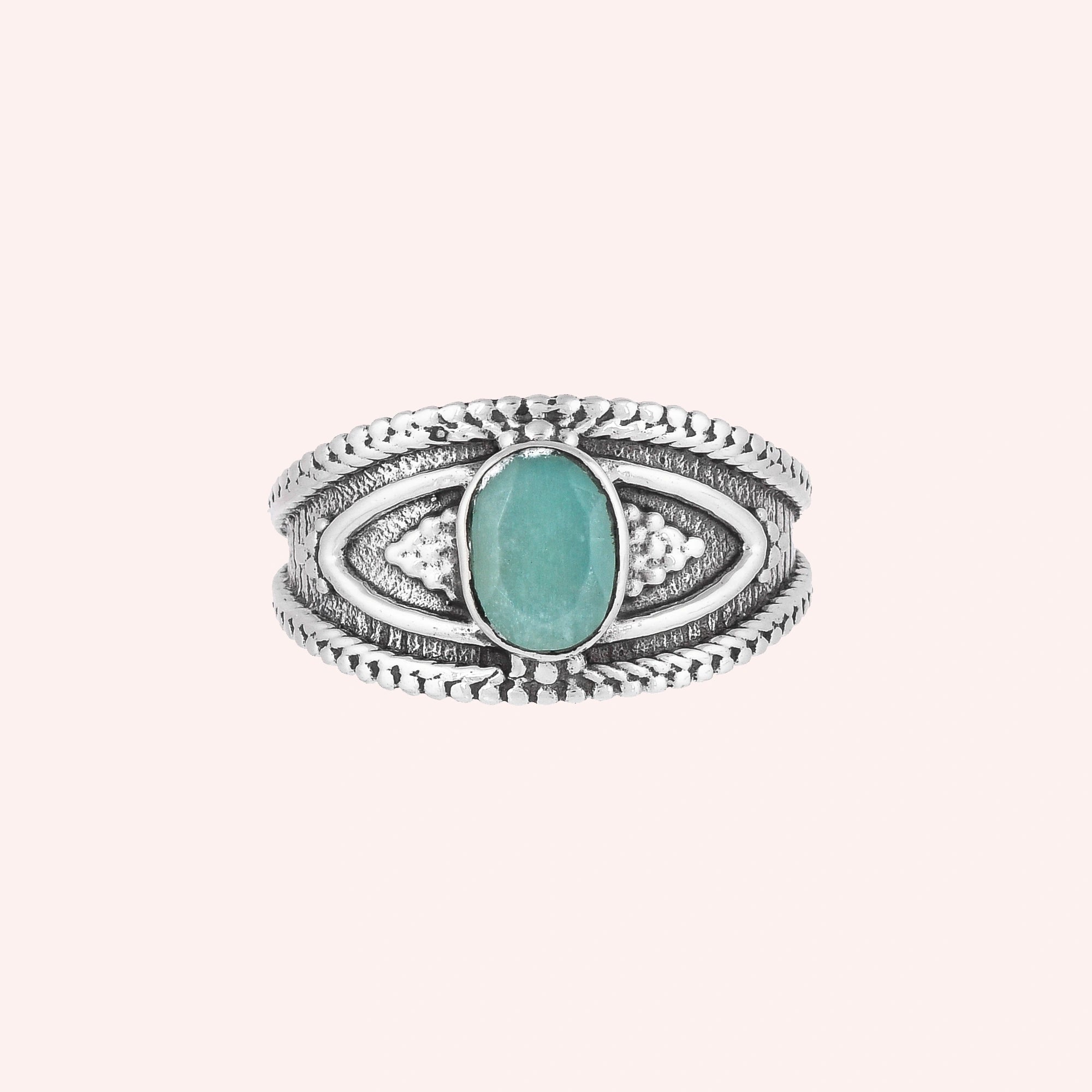 Boho_ring_with_amazonite_stone_sterling_silver_with_filigree_texture_in_front_angle_view_on_solid_pink_background