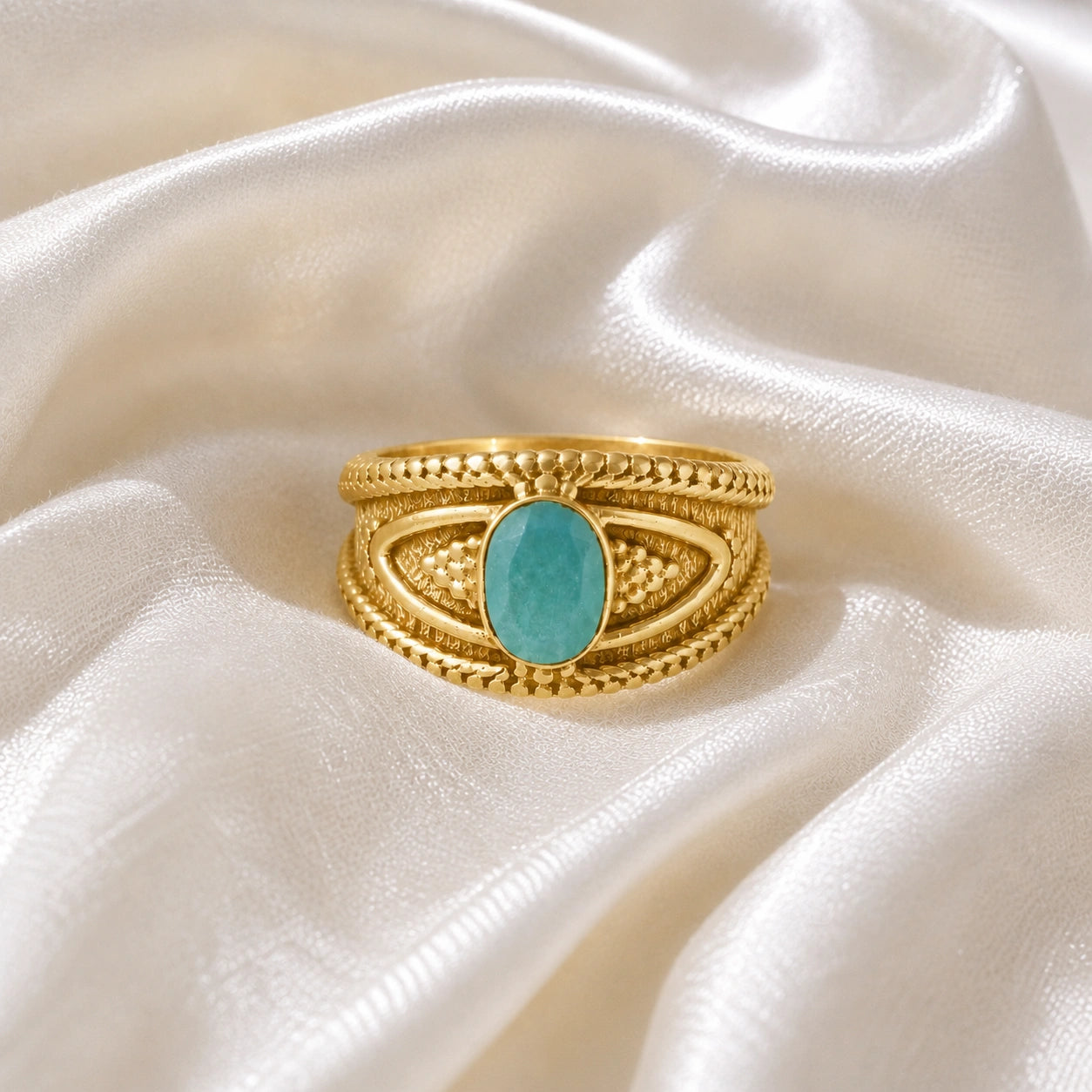 Boho_ring_with_amazonite_stone_gold_plated_silver_with_filigree_texture_in_front_angle_view_on_soft_fabric_background