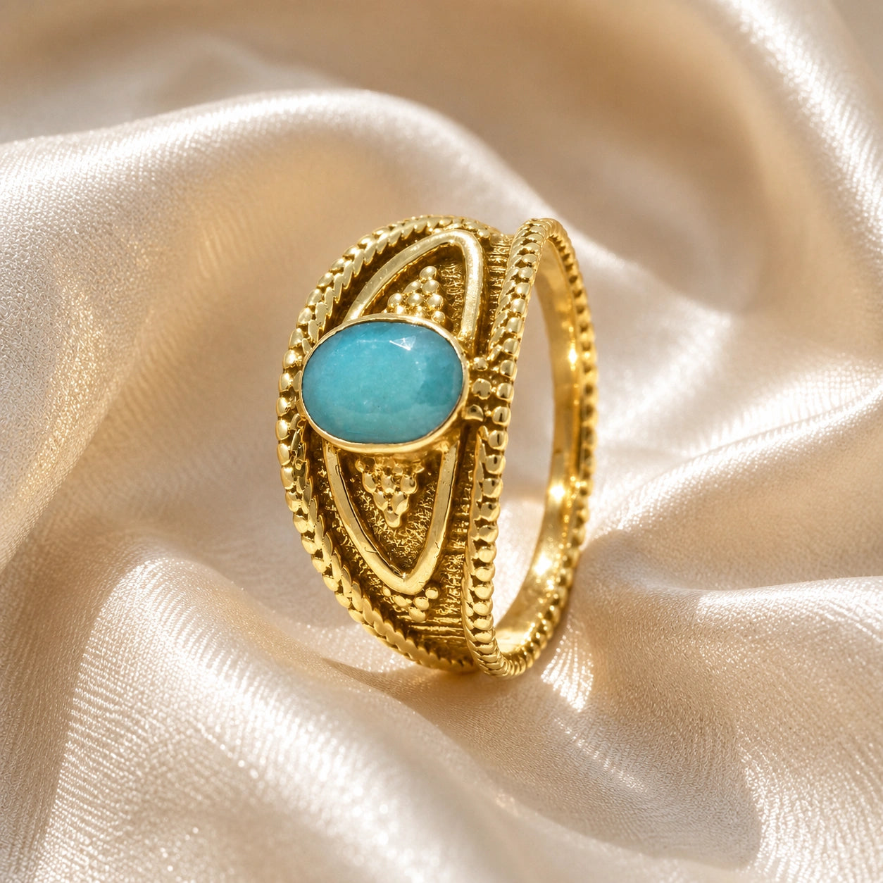 Boho_ring_with_amazonite_stone_gold_plated_silver_with_filigree_texture_in_slightly_angled_on_soft_fabric_background