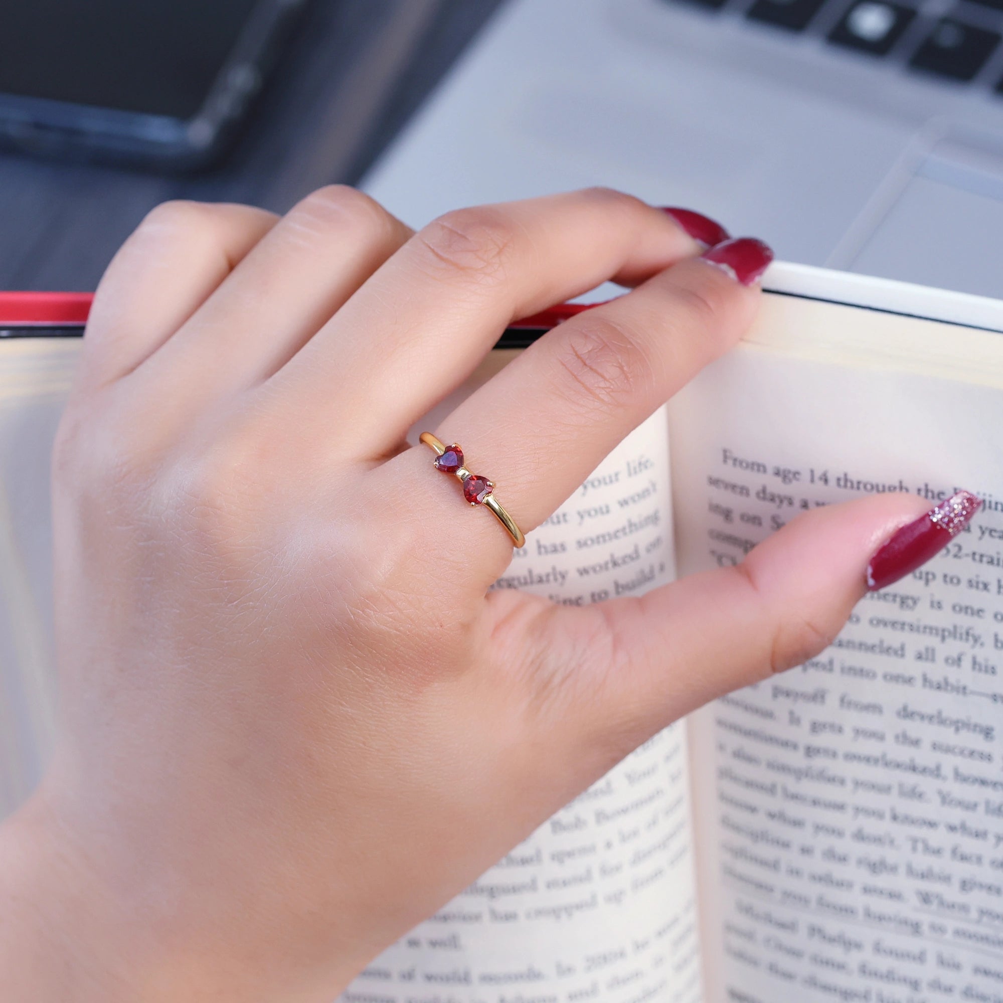Bow_ring_with_gold_plated_silver_band_red_heart_garnet_gemstones_worn_by_a_model