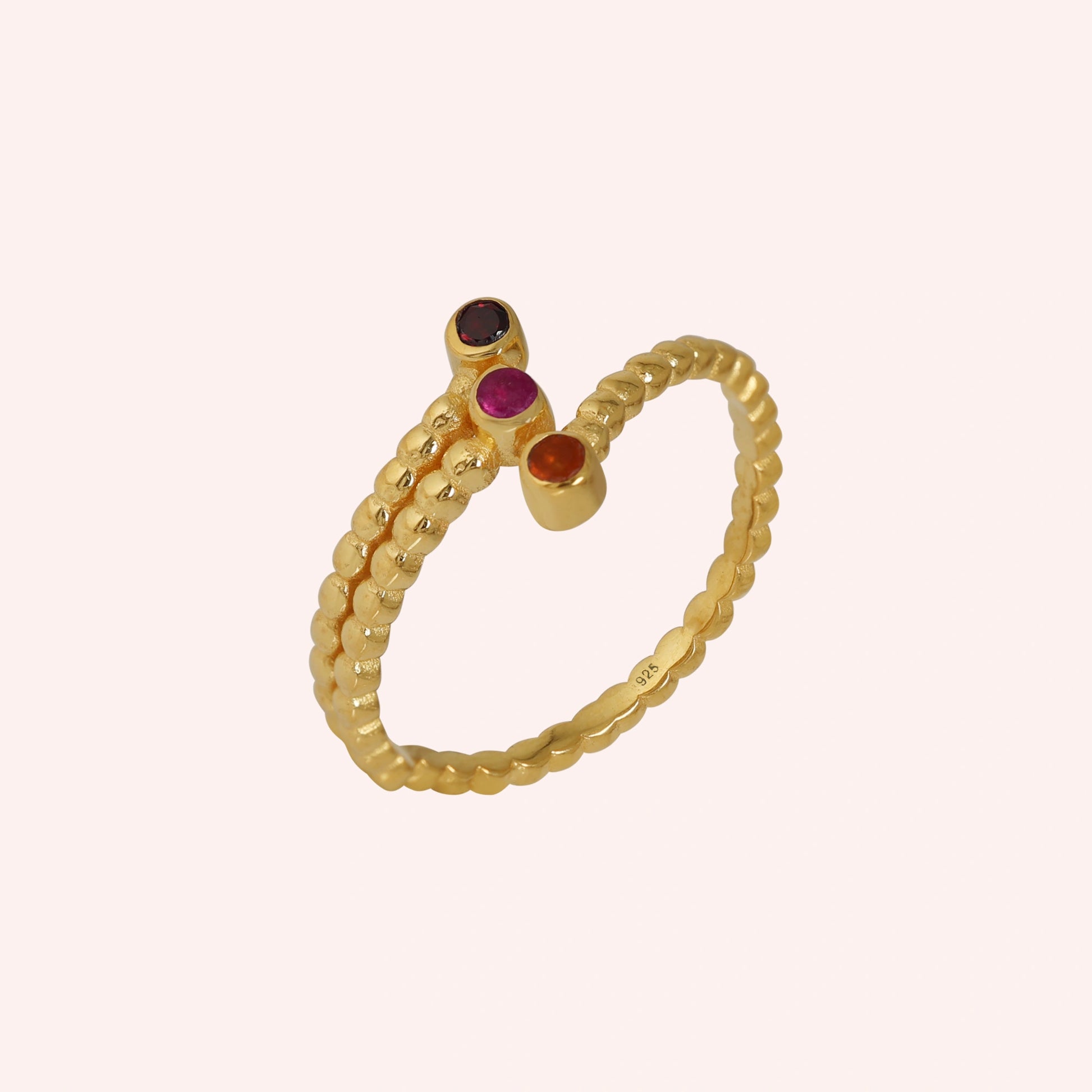 Bubble-ring-with-ruby-carnelian-garnet-gemstones-gold-plated-silver-angled-view-on-soft-pink-background