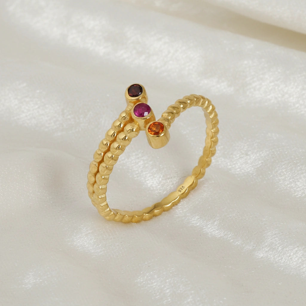 Bubble-ring-with-ruby-carnelian-garnet-gemstones-gold-plated-silver-angled-view-on-white-satin-background