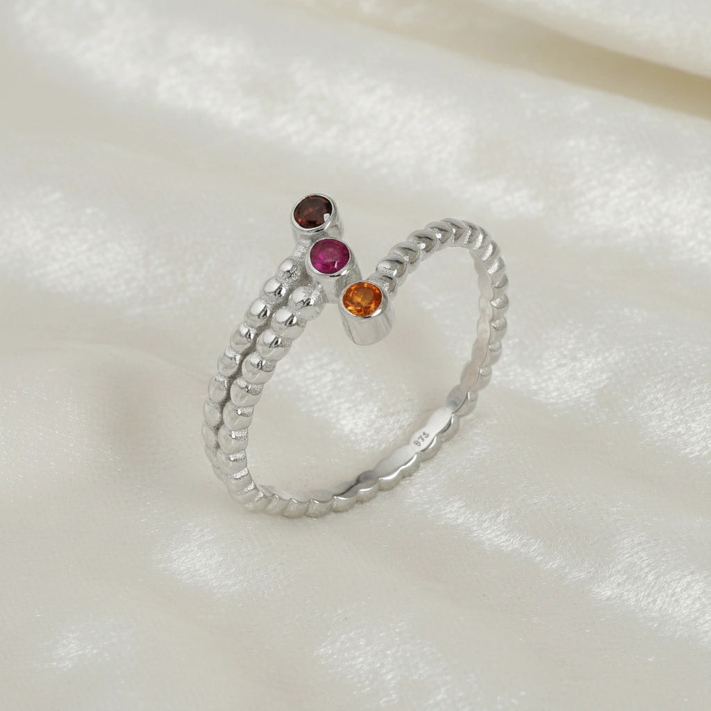 Bubble-ring-with-ruby-carnelian-garnet-gemstones-sterling-silver-angled-view-on-white-satin-background