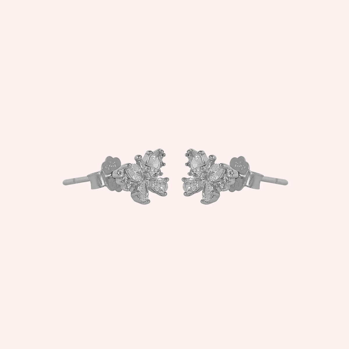 Diamond_butterfly_earrings_in_sterling_silver_with_lab_grown_diamonds_at_side_angle_view_on_solid_pink_background