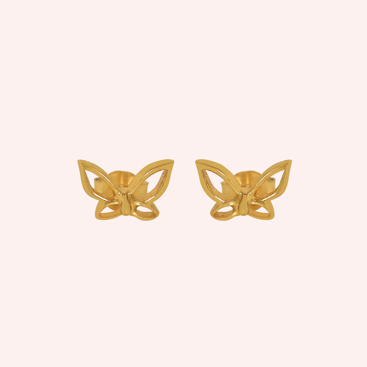 Butterfly_earrings_in_gold_plated_silver_in_a_stud_design_at_front_angle_view_on_solid_pink_background