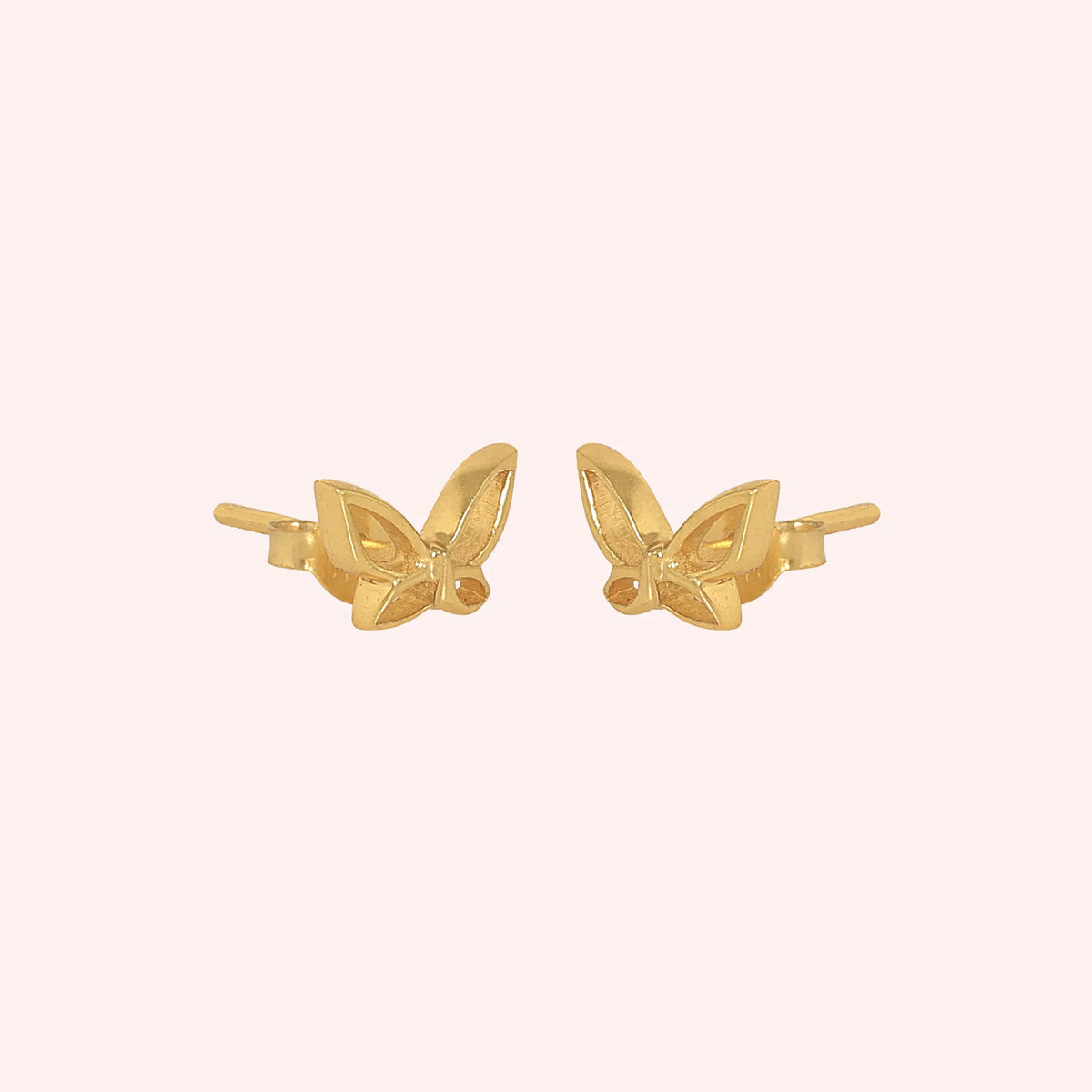 Butterfly_earrings_in_gold_plated_silver_in_a_stud_design_at_side_angle_view_on_solid_pink_background