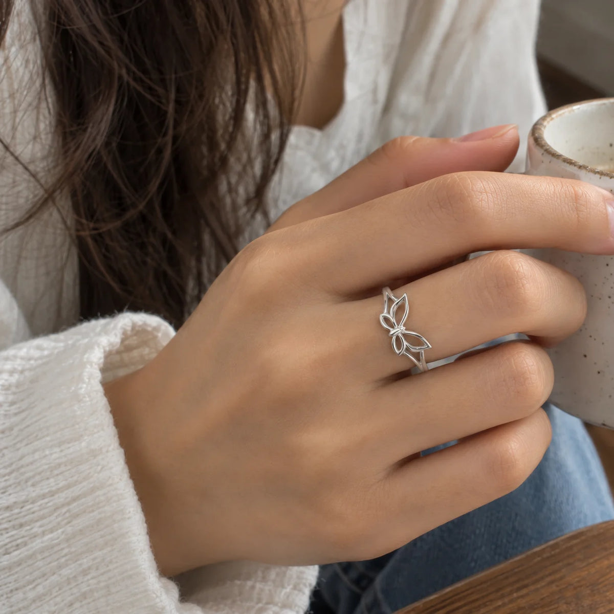 Butterfly_ring_in_sterling_silver_at_front_angle_view_worn_by_a_model