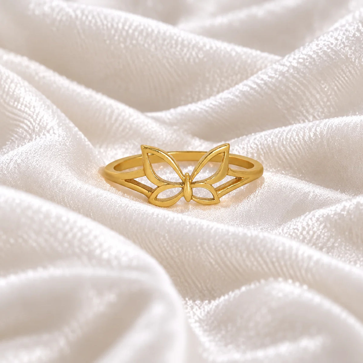Butterfly_ring_in_gold_plated_silver_at_front_angle_view_on_soft_fabric_background