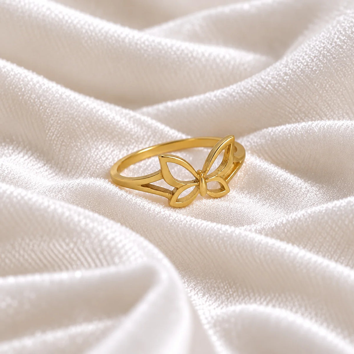 Butterfly_ring_in_gold_plated_silver_at_side_angle_view_on_soft_fabric_background