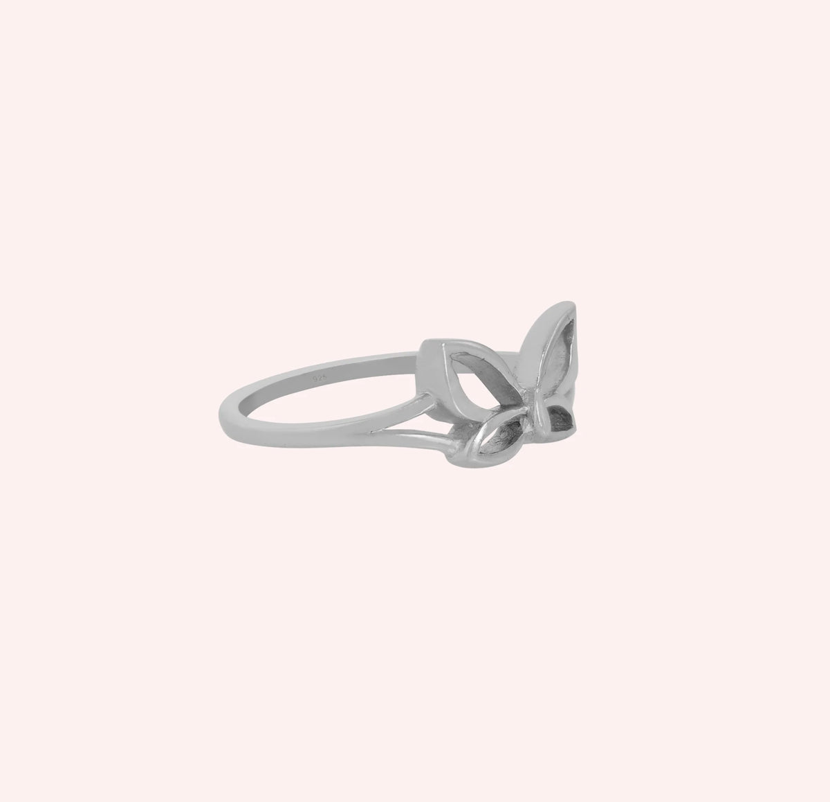 Butterfly_ring_in_sterling_silver_at_side_angle_view_on_solid_pink_background