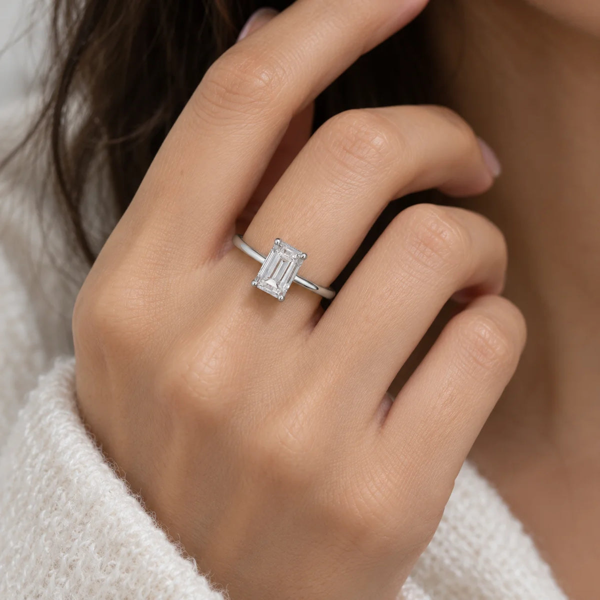CZ_ring_in_sterling_silver_with_a_baguette_shaped_CZ_at_front_view_worn_by_a_model