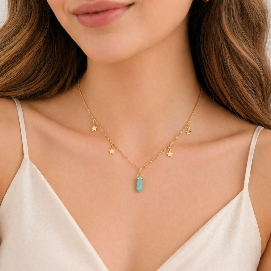 Charm_necklace_in_front_angled_view_with_gold_plated_silver_chain_star_charms_and_amazonite_stone_on_soft_fabric_background