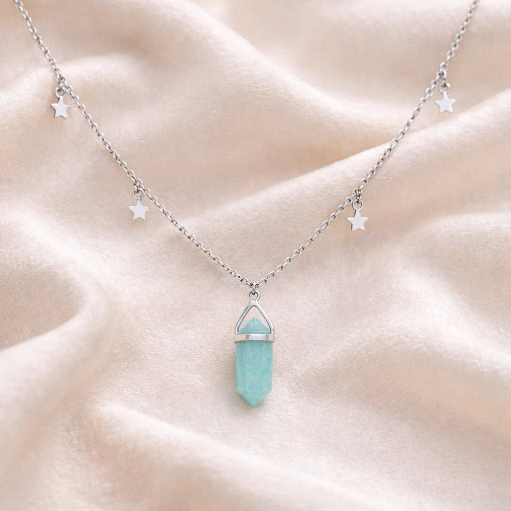 Charm_necklace_in_front_angled_view_with_sterling_silver_chain_star_charms_and_amazonite_stone_on_soft_fabric_background